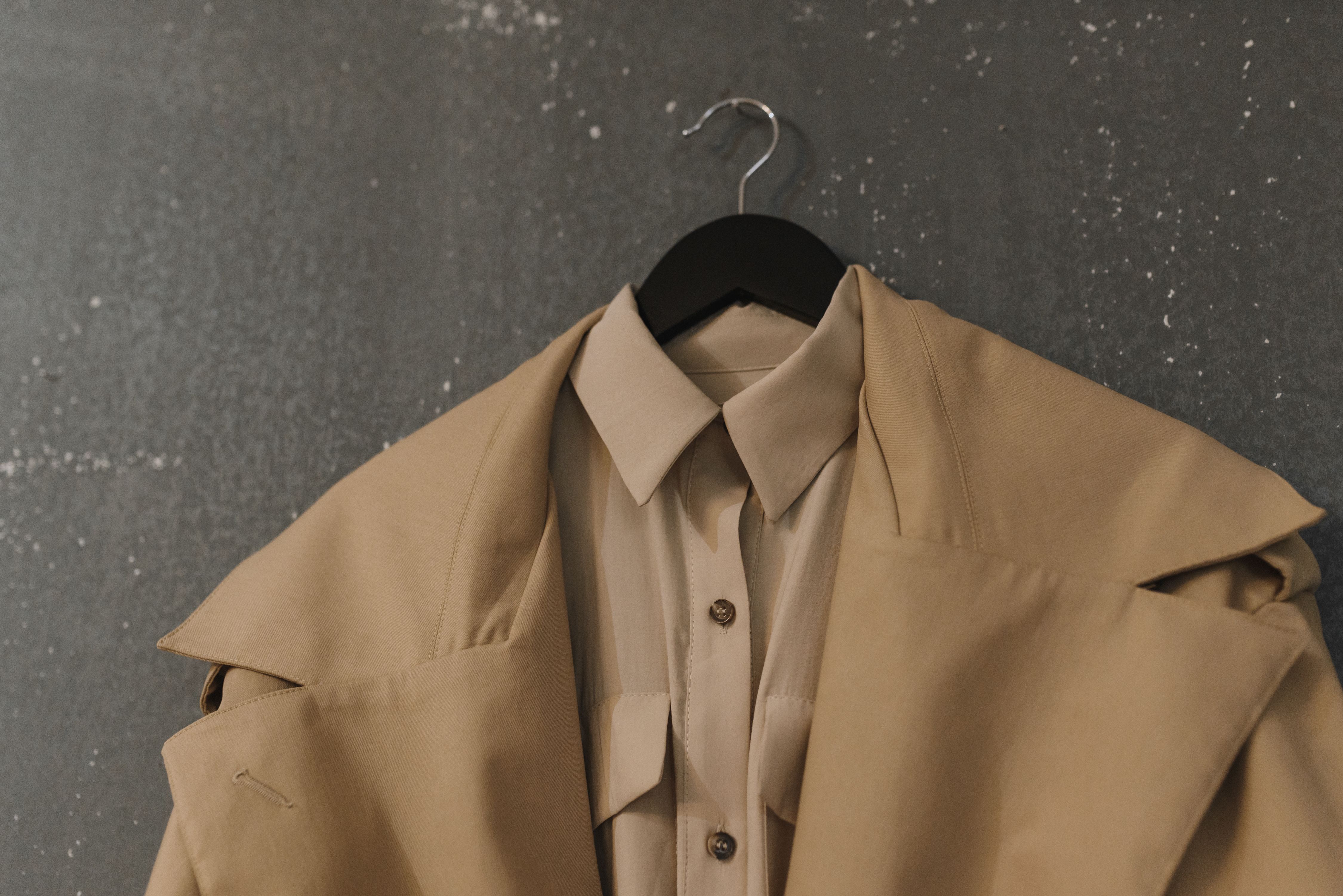 stylish-beige-coat-and-shirt-on-hanger,-perfect-for-autumn-fashion. - arina-krasnikova (pexels)