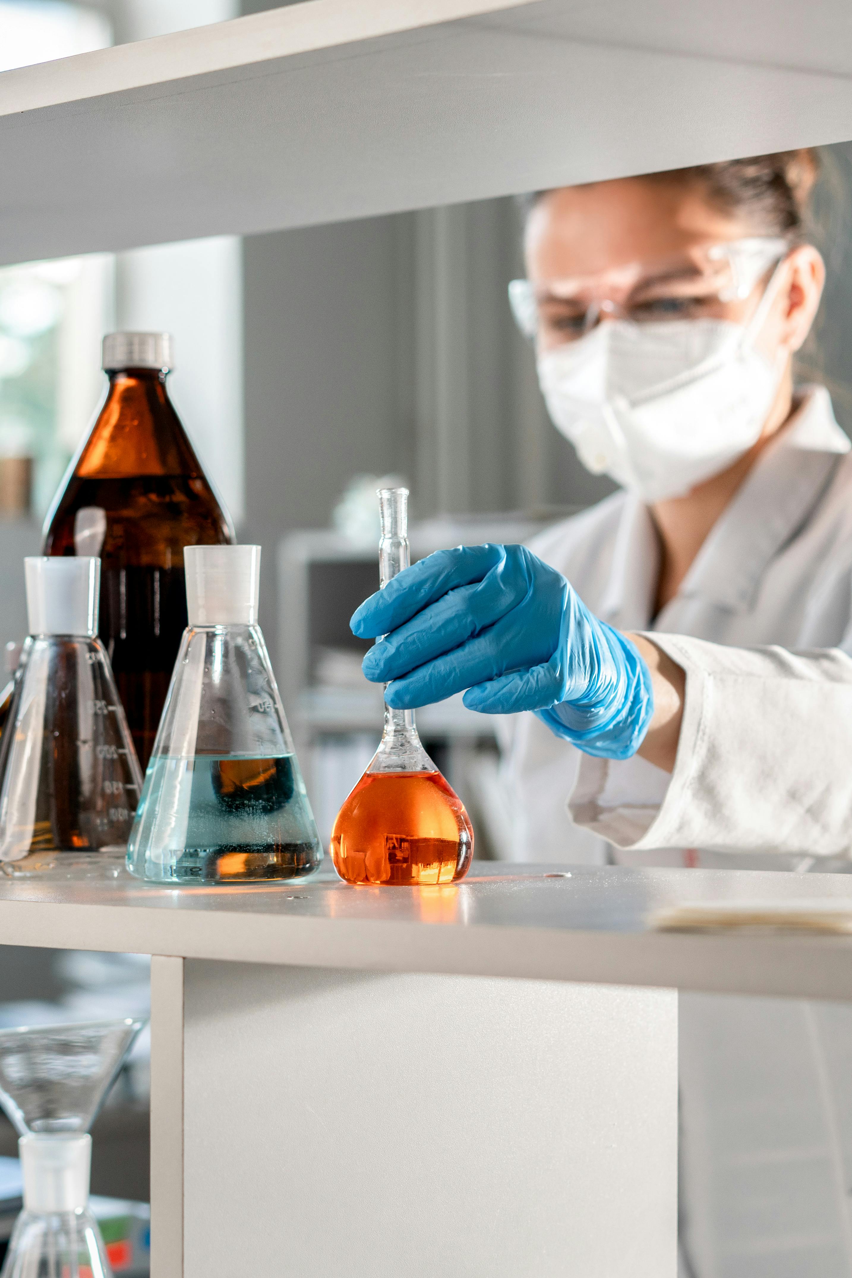 Lab technician kept a small chemical bottle in a stand