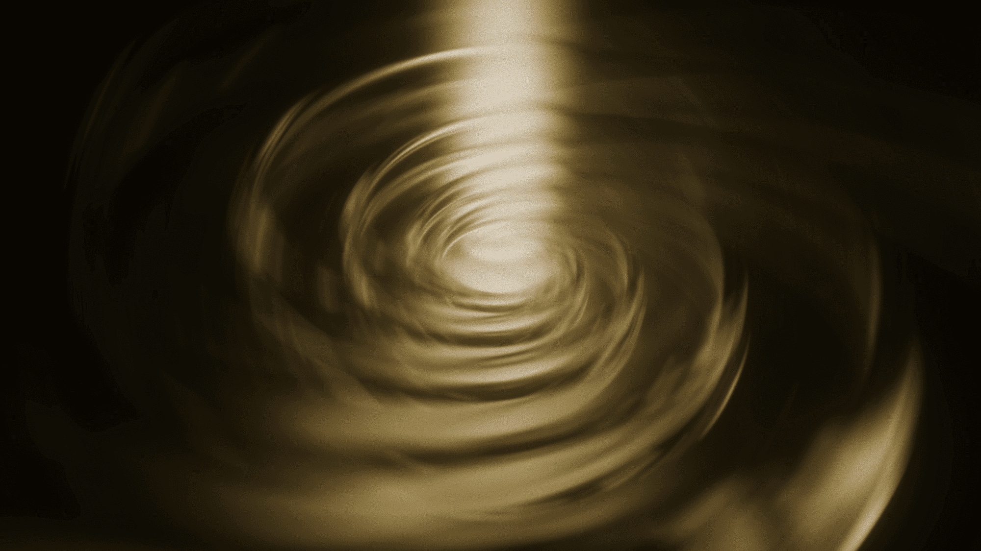 Abstract golden swirling vortex pattern with a bright central light beam