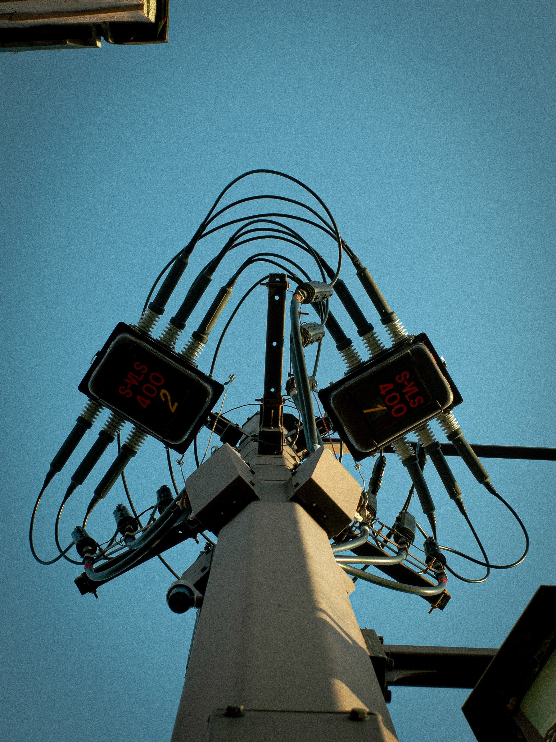 A close-up of a person wearing green-tinted glasses, with a serious expression and smooth skin.