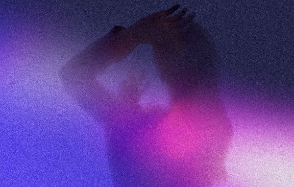 a person riding a snowboard on top of a sandy hill