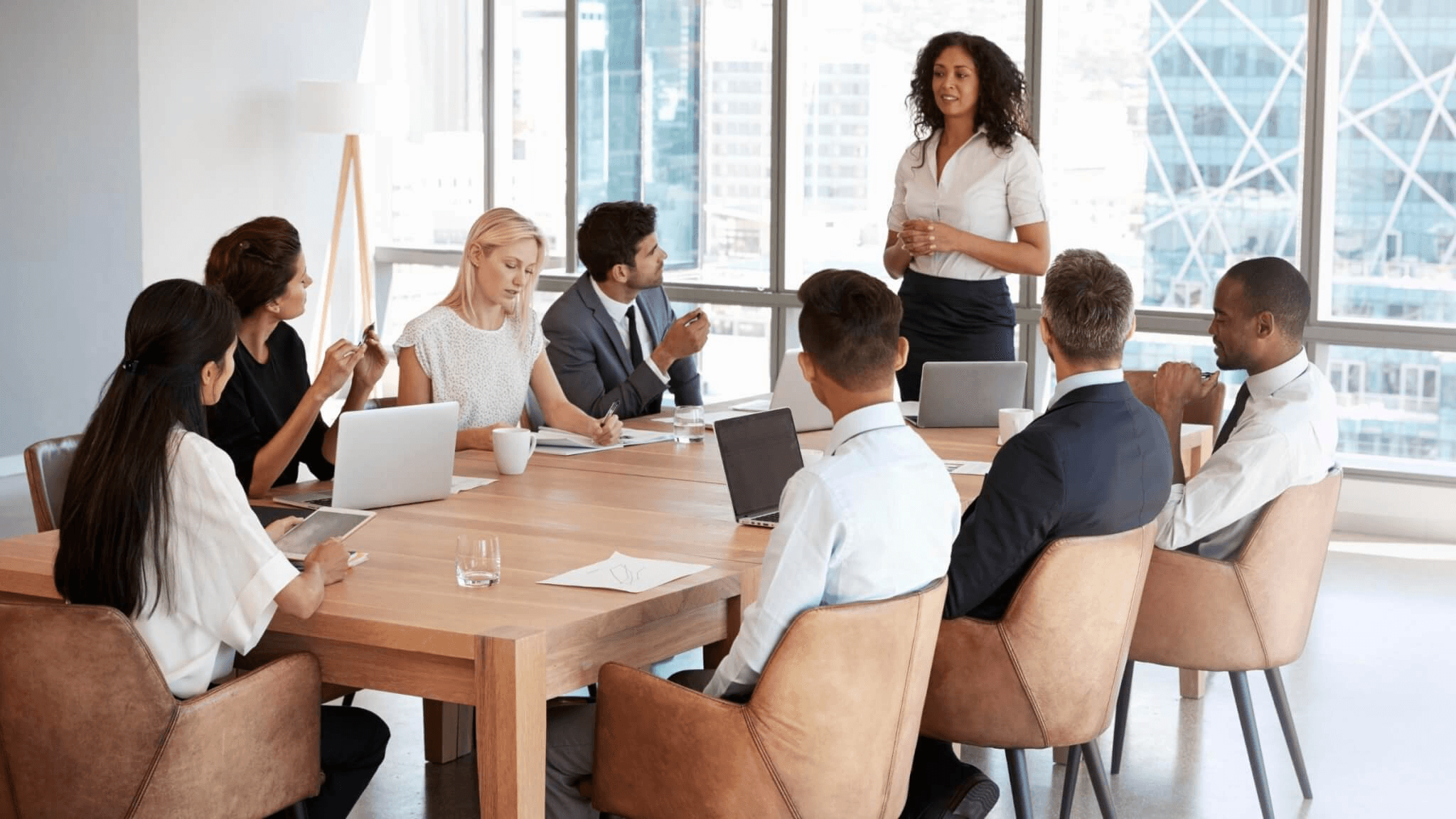 Manager leading meeting in office - How To Follow Up With A Sales Lead