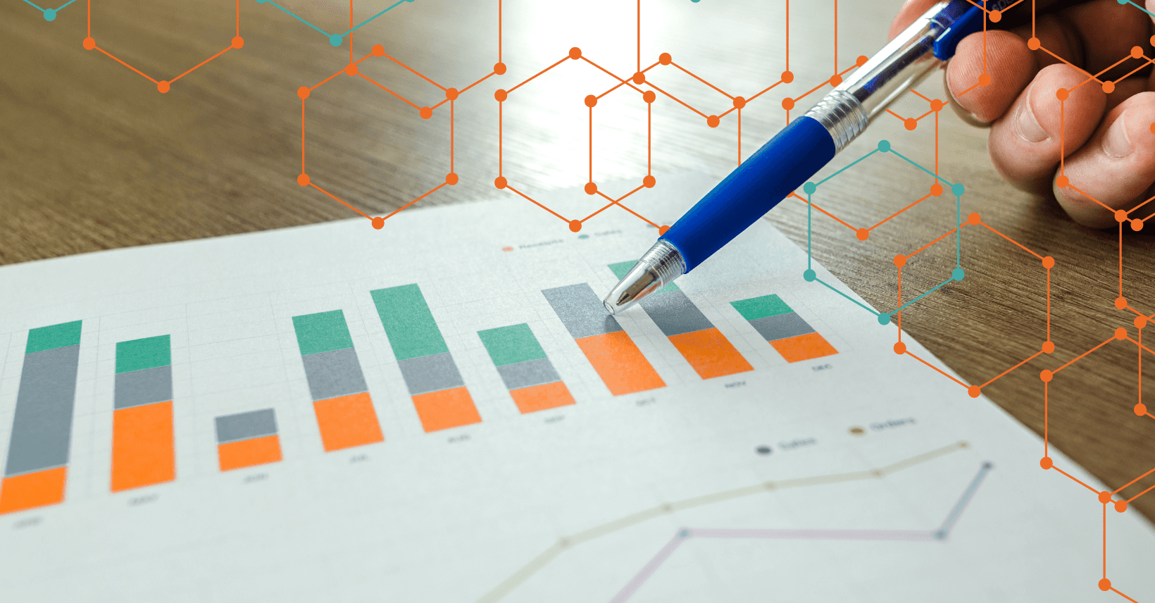Pen pointing at data on a piece of paper