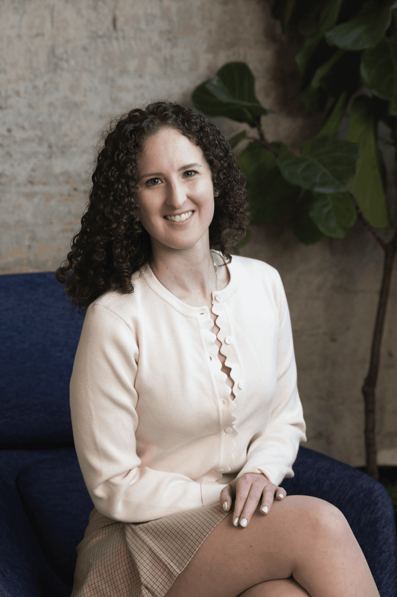 Picture of Theresa smiling and sitting in a chair