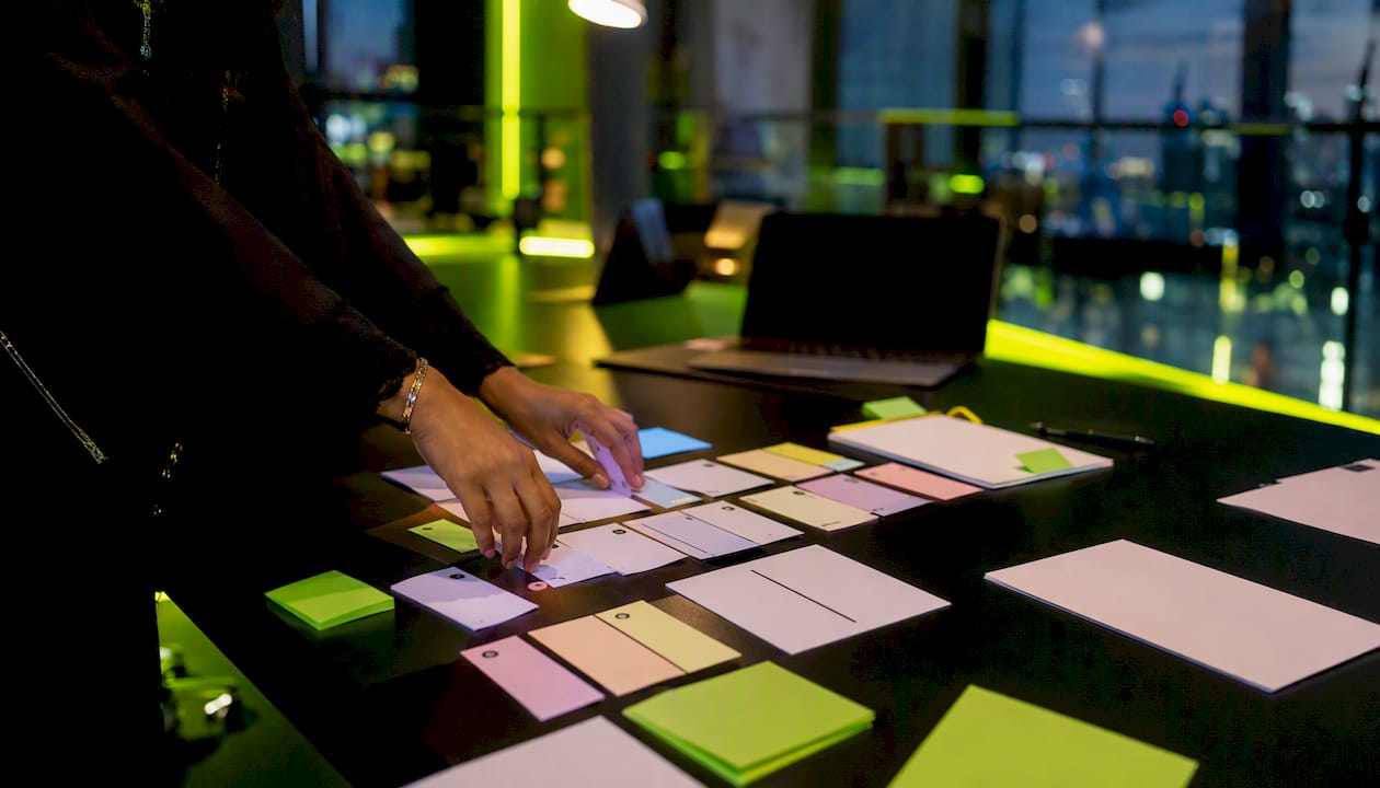 Hands organizing project planning materials