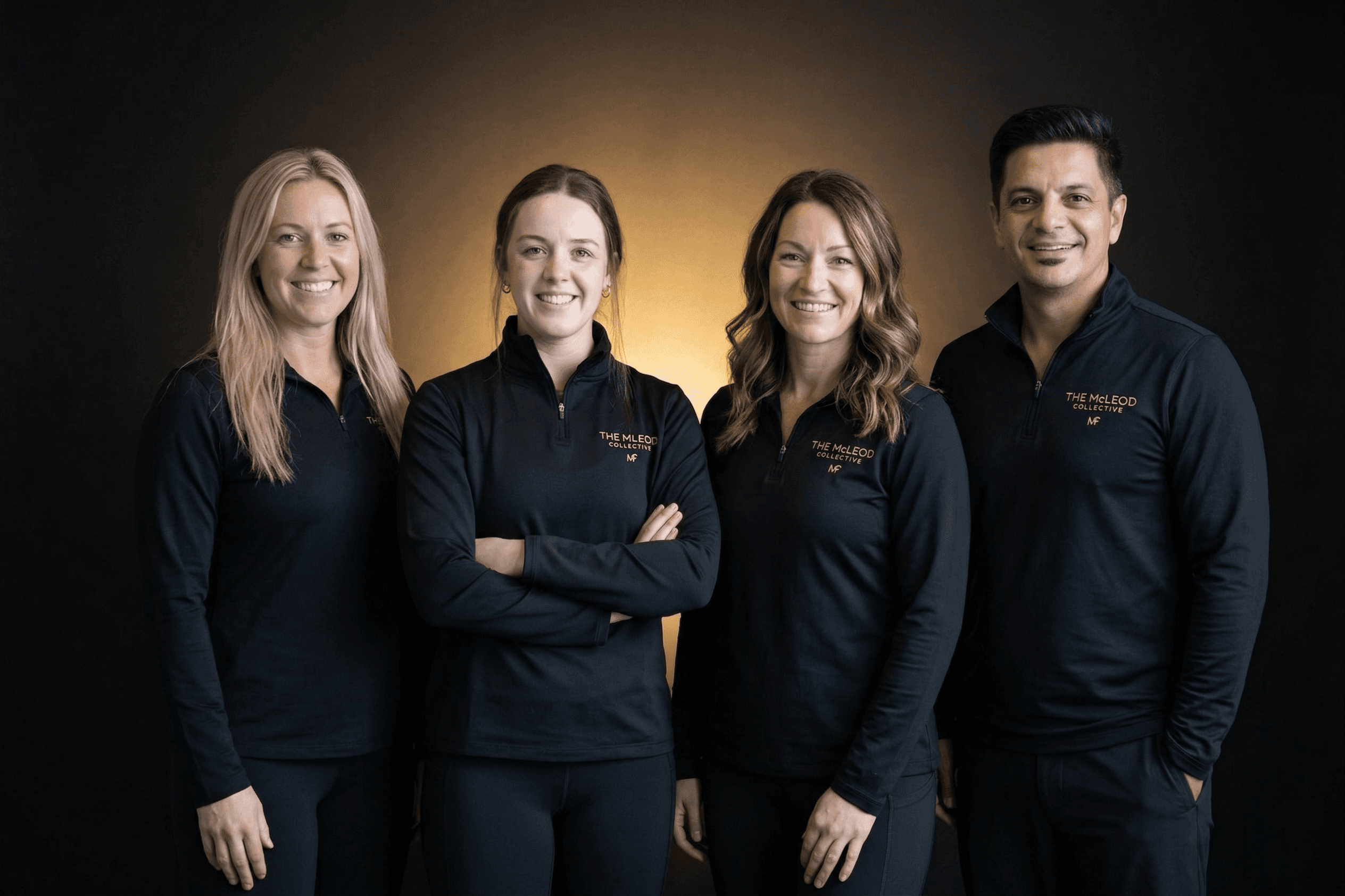 Five women posing together wearing black t-shirts.