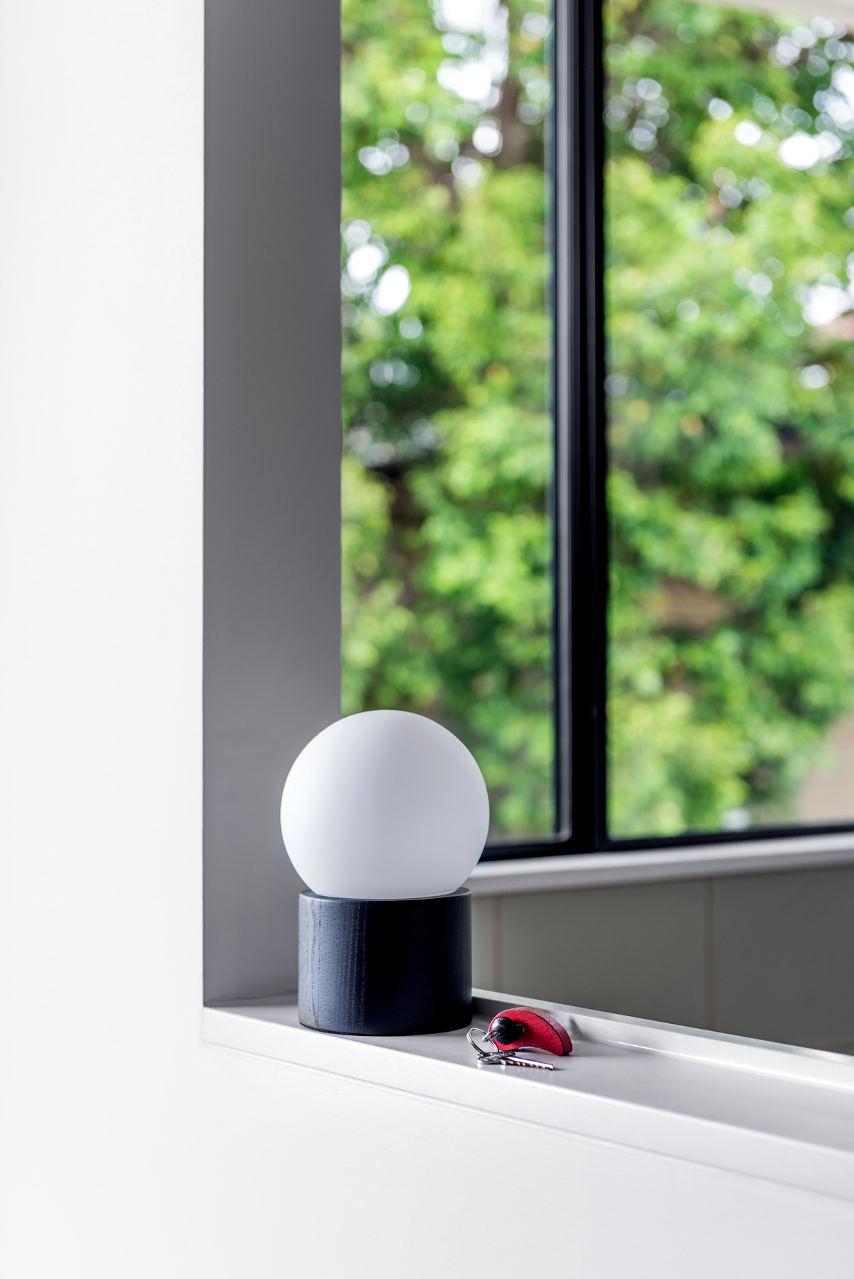 Window sill detail at Glenhaven Kitchen with a sculptural lamp and soft daylight framing views into the garden.