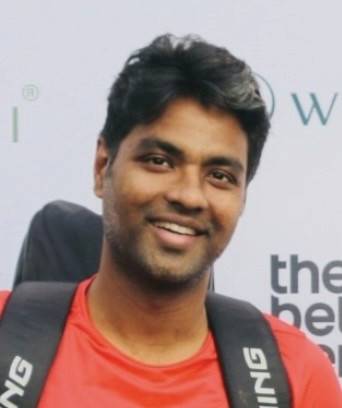 man in gray crew neck t-shirt and gray shorts sitting on basketball court