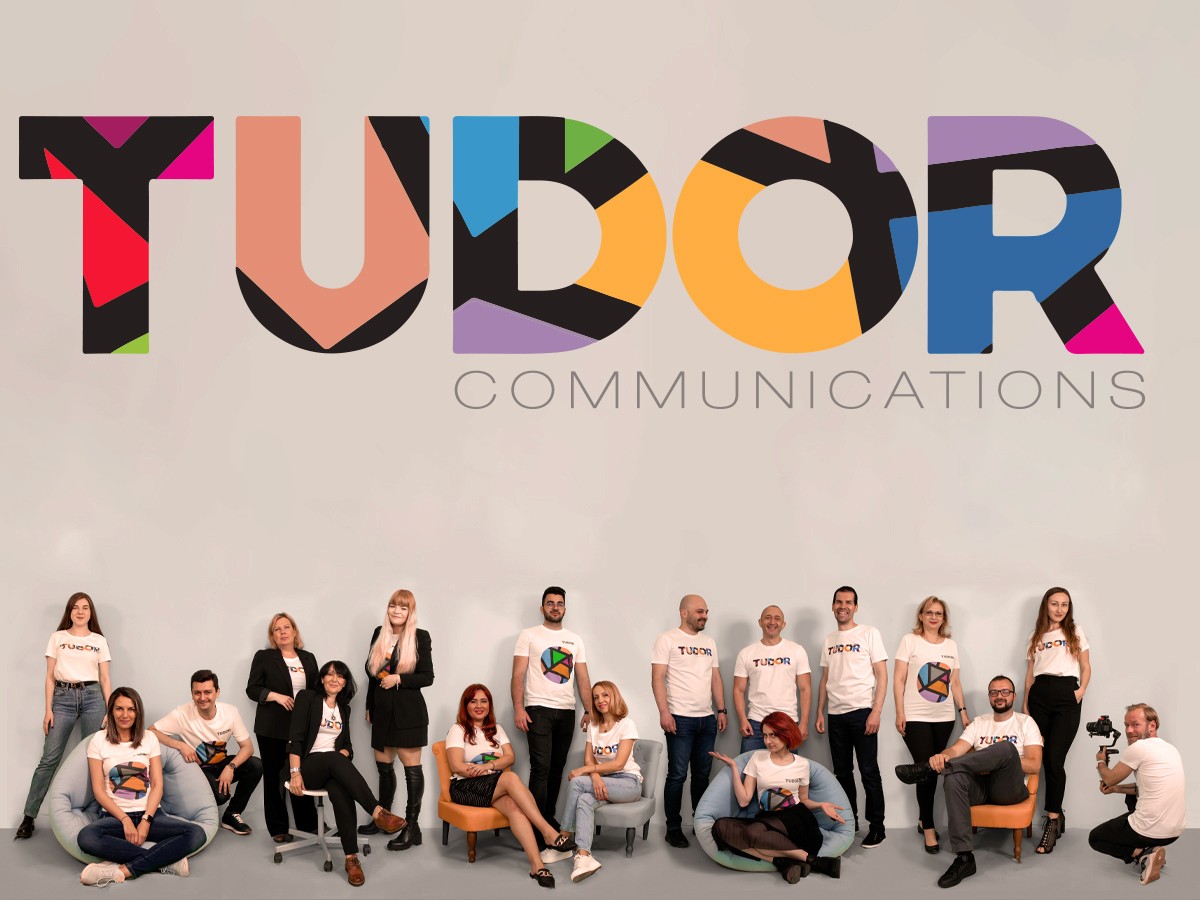 Tudor Communications - echipa in fata peretelui cu logo