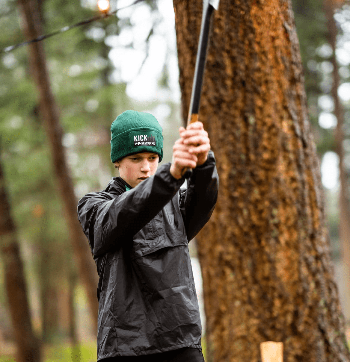 a group of people sitting around a table with laptops