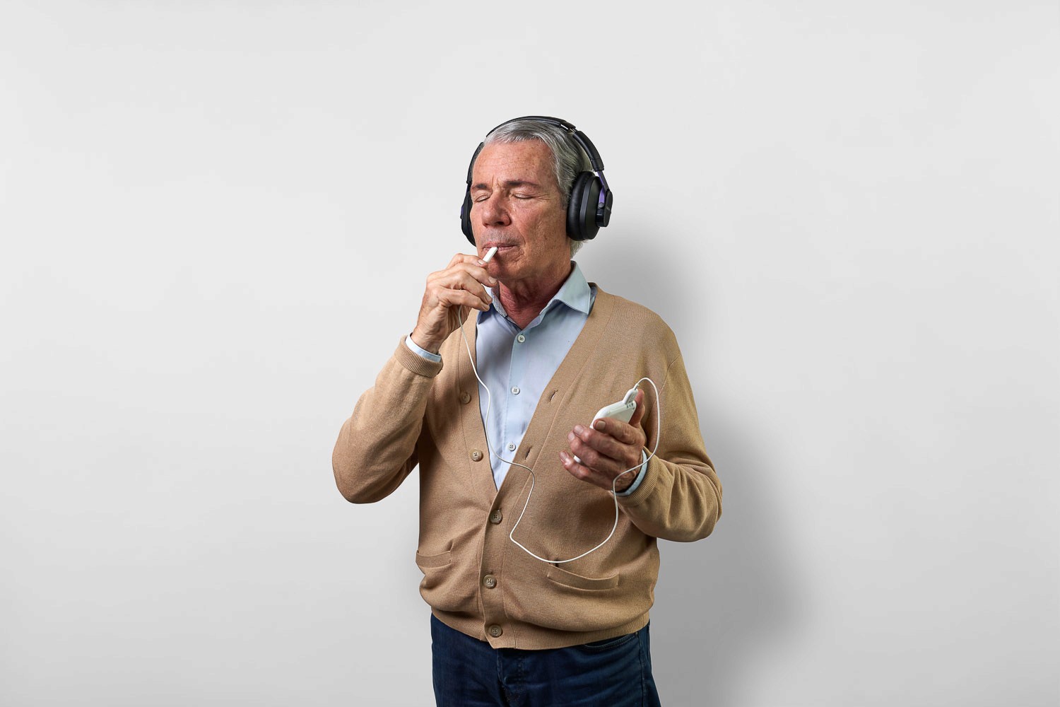 Man sitting in a testing booth having a hearing test