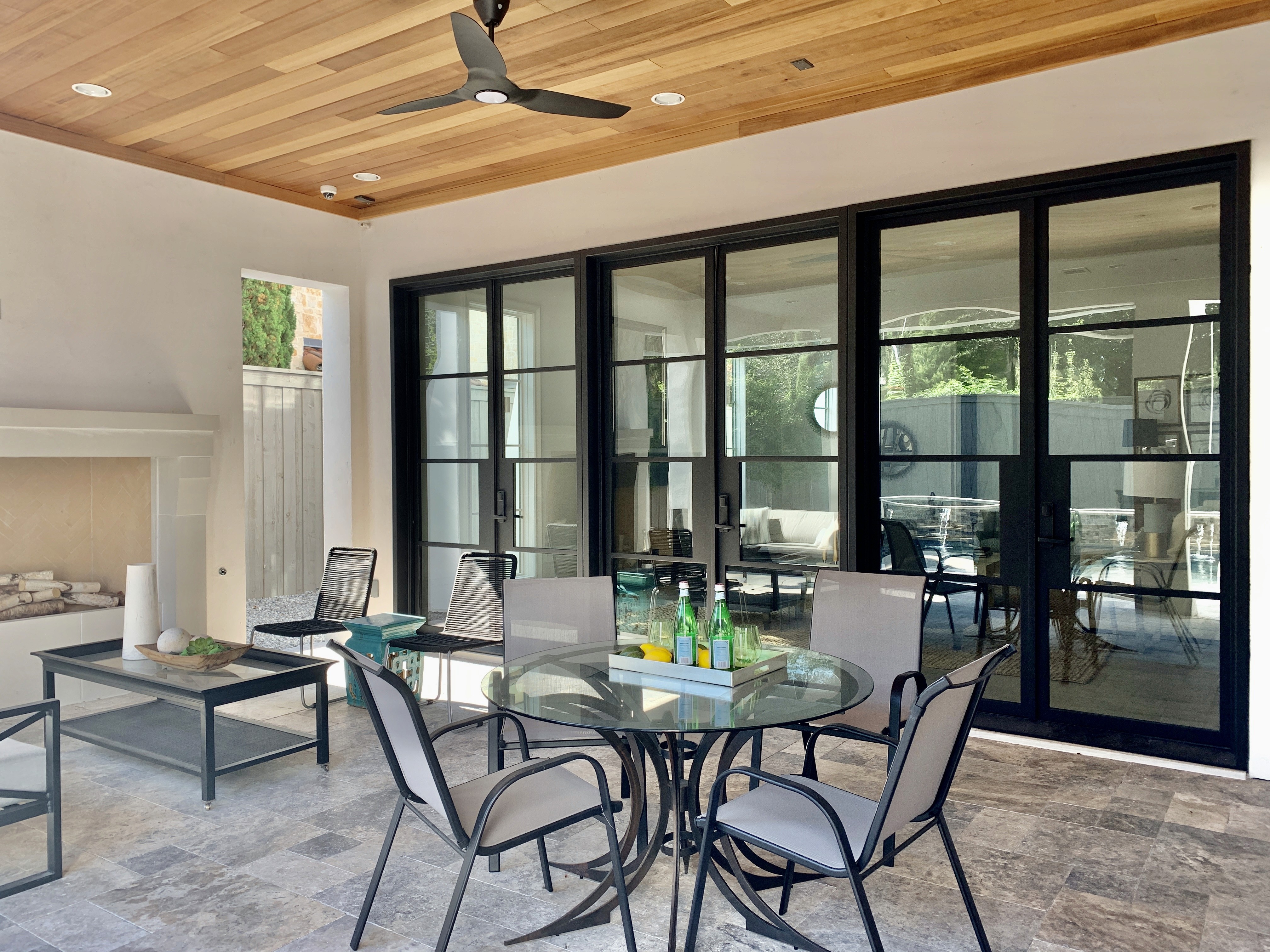 Patio opening with wood and glass looking out to planted landscape