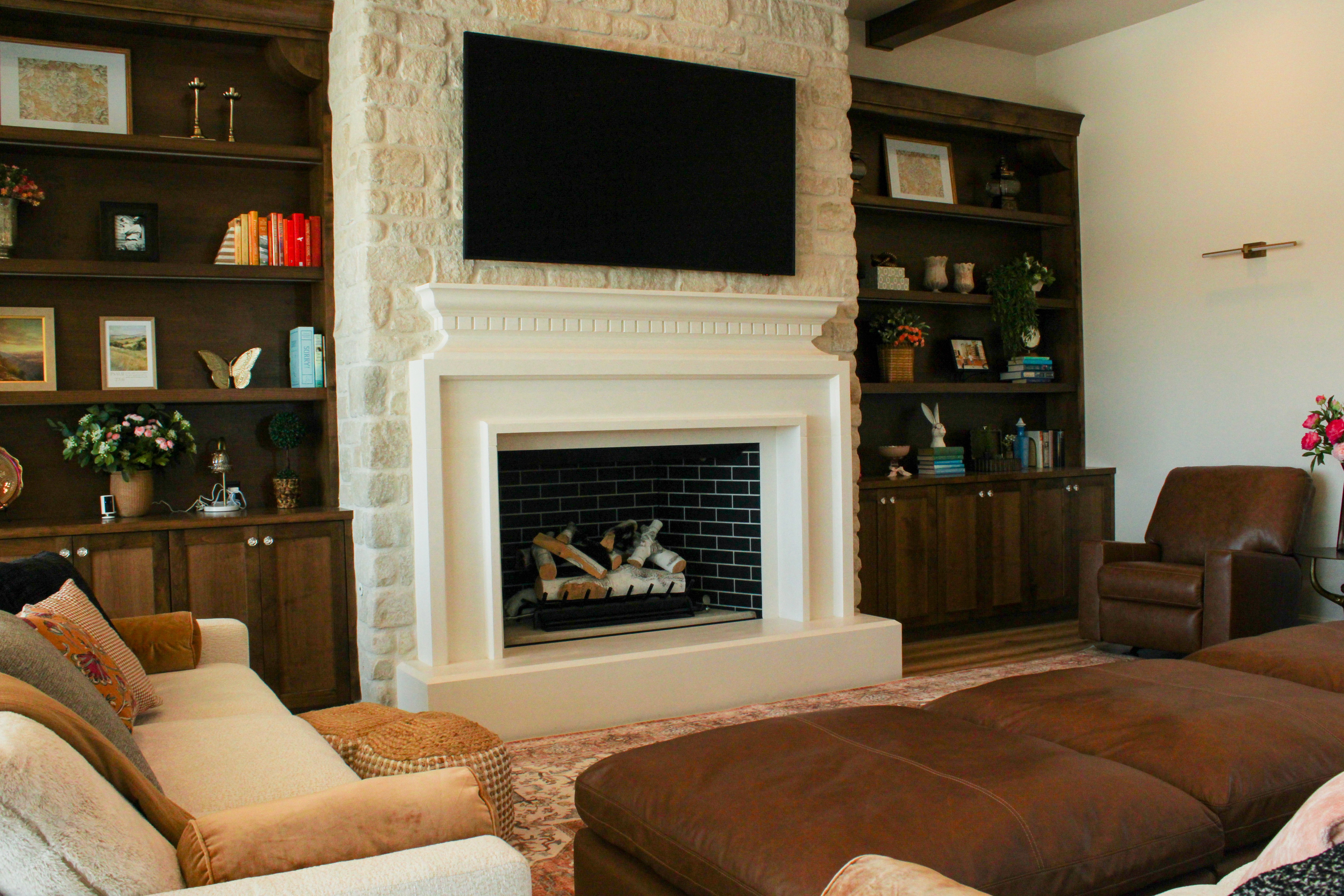 Great room with a fireplace, custom shelving, and open layout in a custom home in St. George, Utah.
