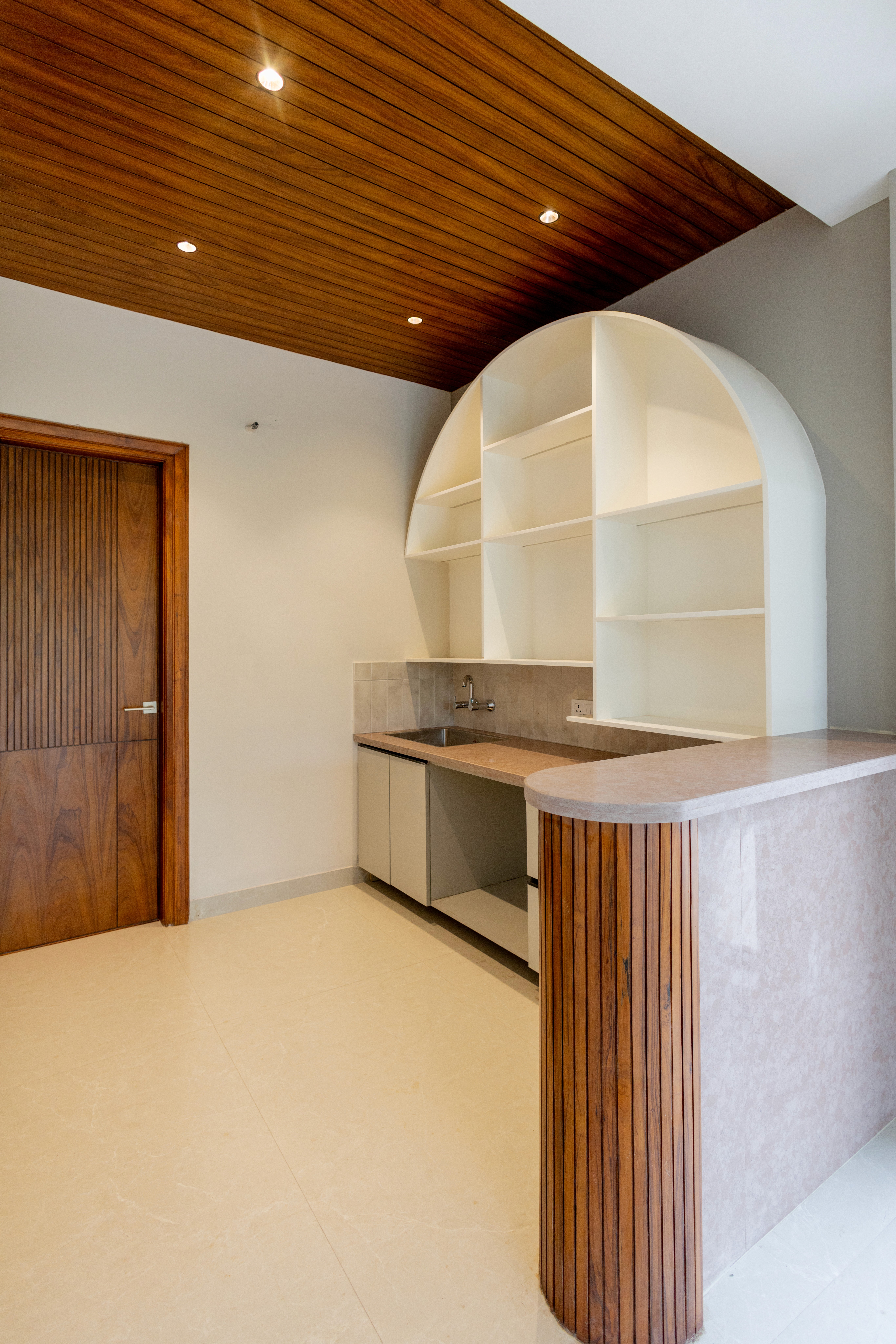 Modern interior entrance with floor-to-ceiling glass walls and warm timber cladding overlooking landscape