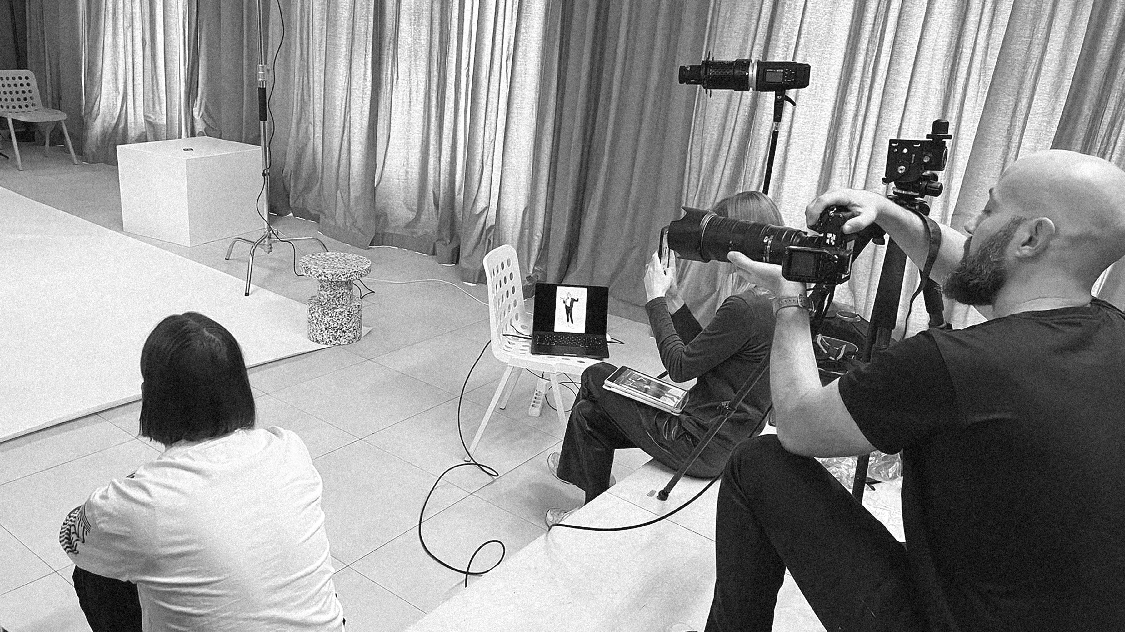 Photographer in the studio during the photoshoot of a new sportswear line.