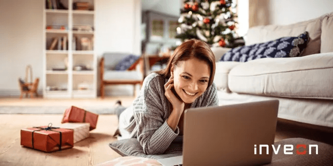 thumbnail image showing a woman shopping on their laptop in a festive room with gift packages around