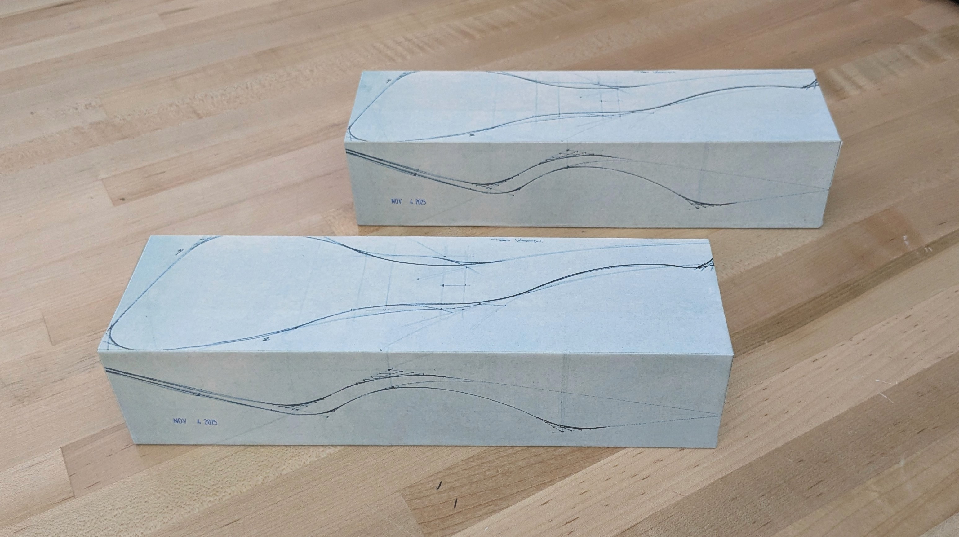 Sketched orthographics placed onto the wood and foam blocks for bandsaw cutting