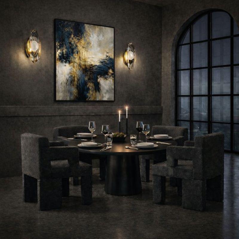 Sophisticated dining interior featuring bronze sculptural wall sconces, contemporary furniture, abstract artwork, and atmospheric evening lighting.
