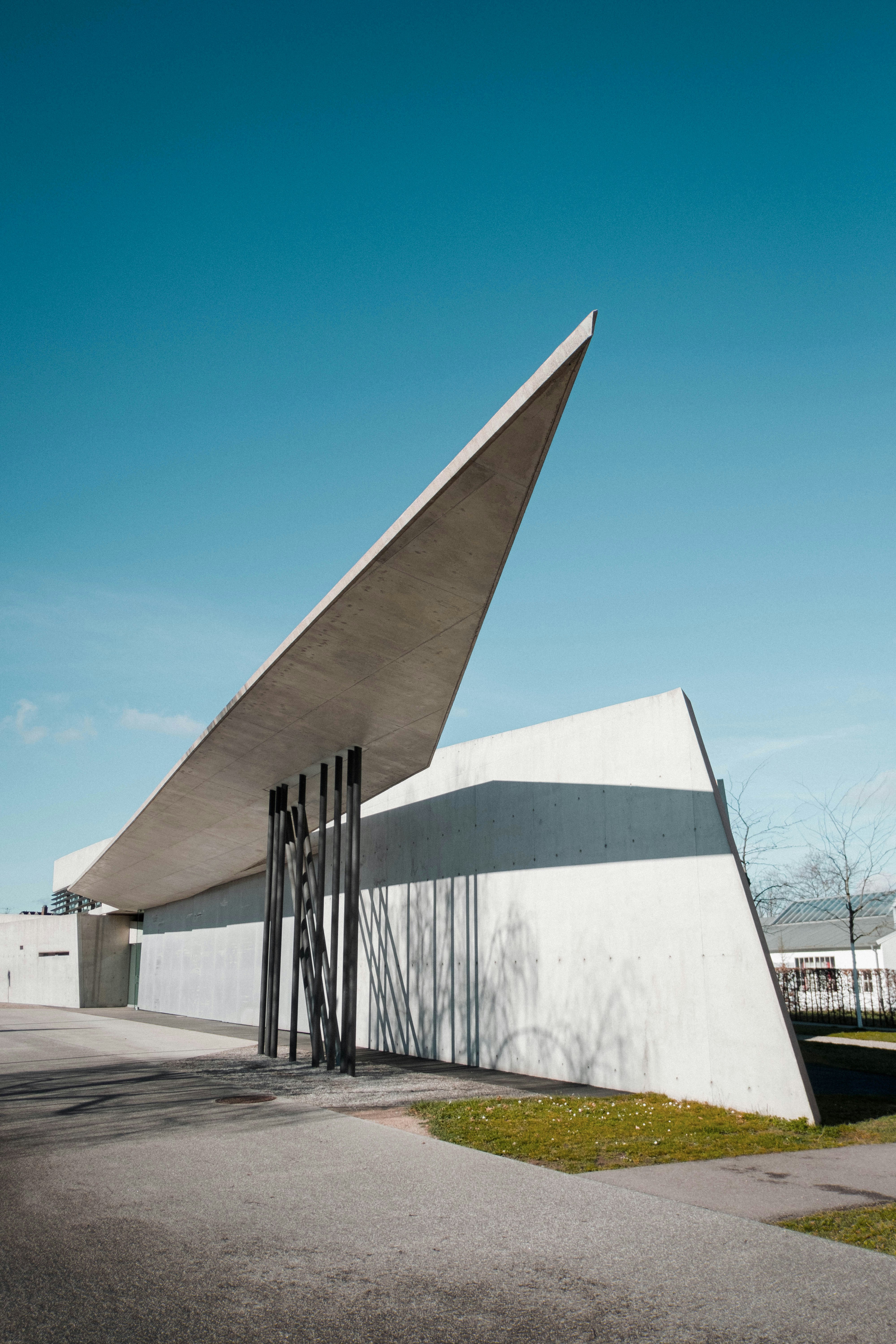 a white building with a large triangular roof