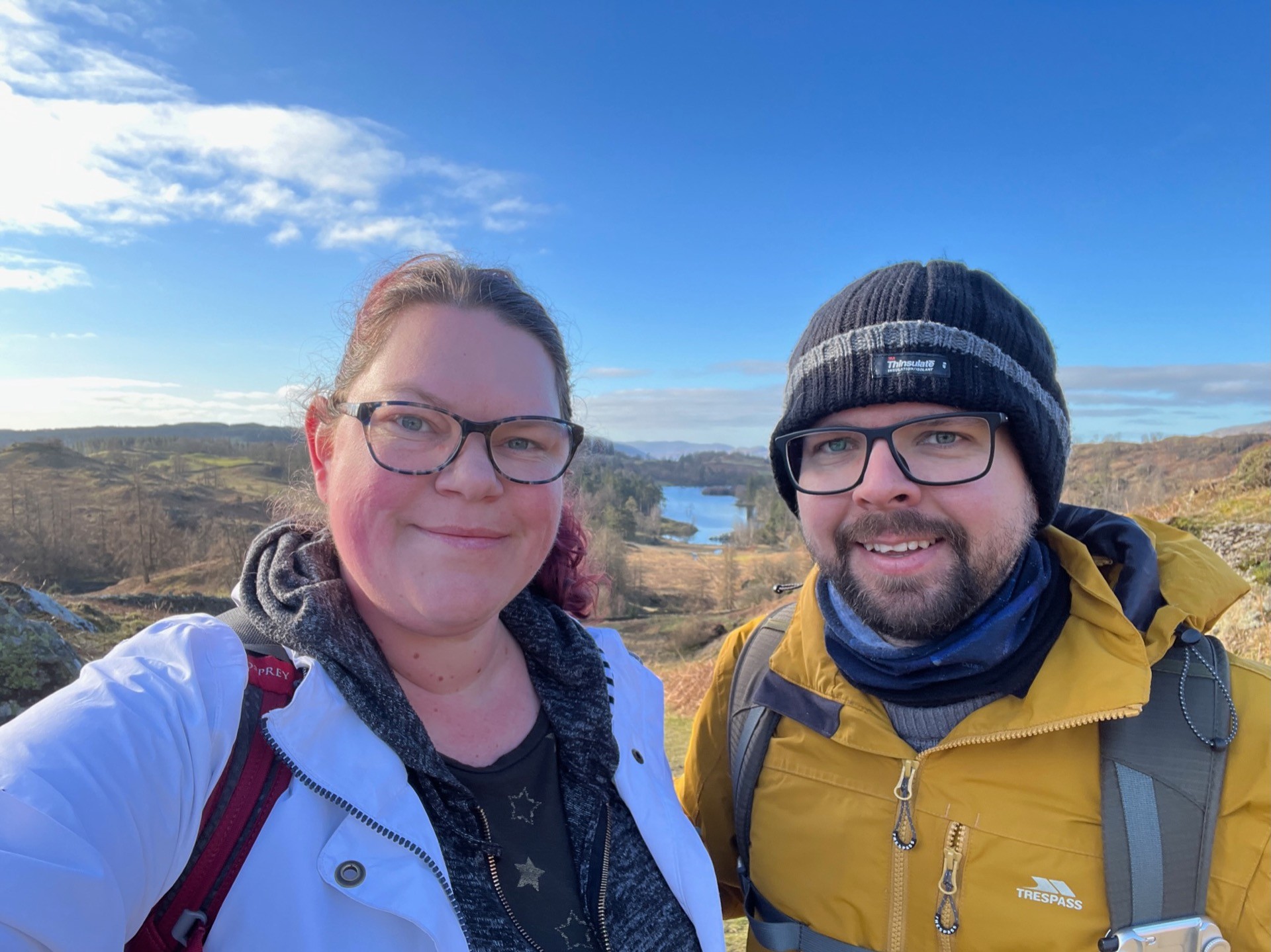 A selfie of Martin and April with Tarn Hows in the background between us.