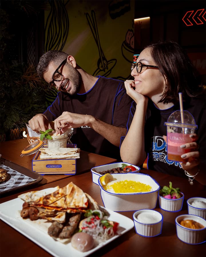 Friends sharing traditional ramadan iftar dishes.