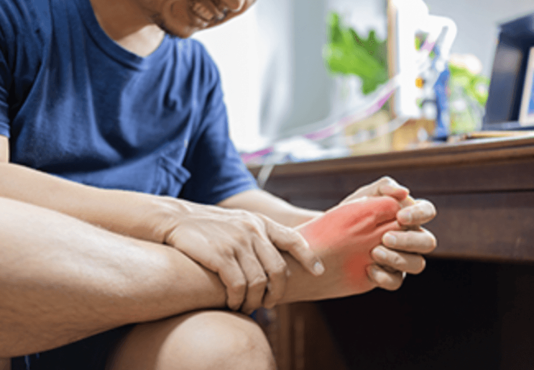 man holding foot in pain highlighting gout and inflammation related to weight