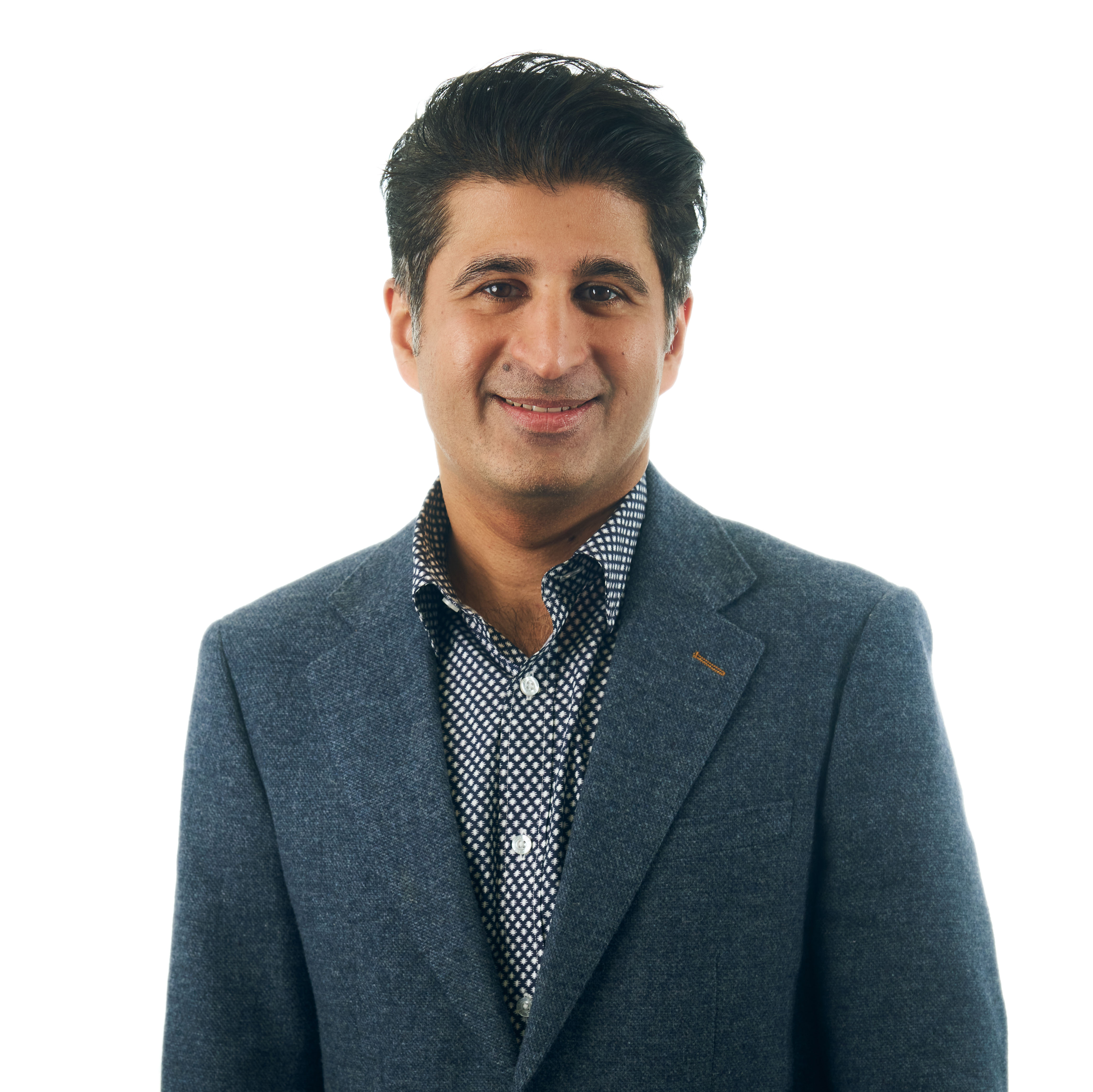 Professional headshot of a business advisor in a white shirt, smiling confidently against a warm neutral background.
