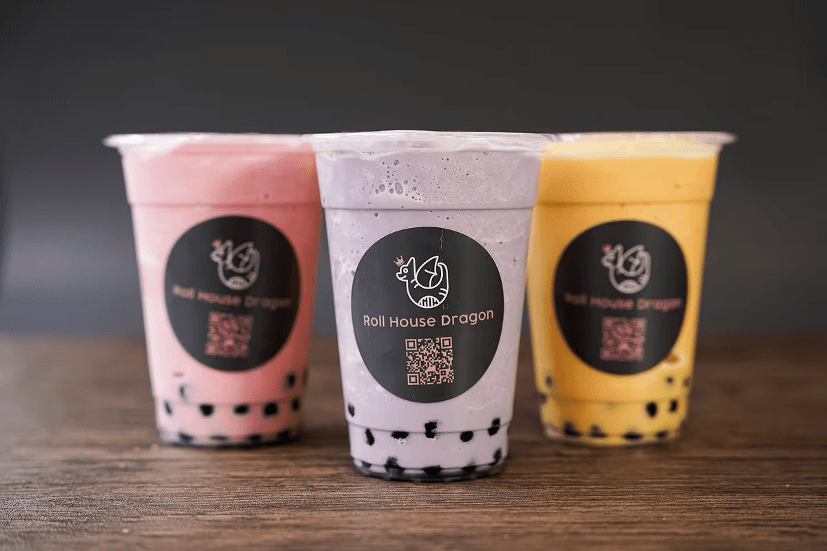 A refreshing boba tea served in a clear cup, showcasing its colorful layers of milk tea, tapioca pearls, and ice—an ideal treat for students and bubble tea enthusiasts near