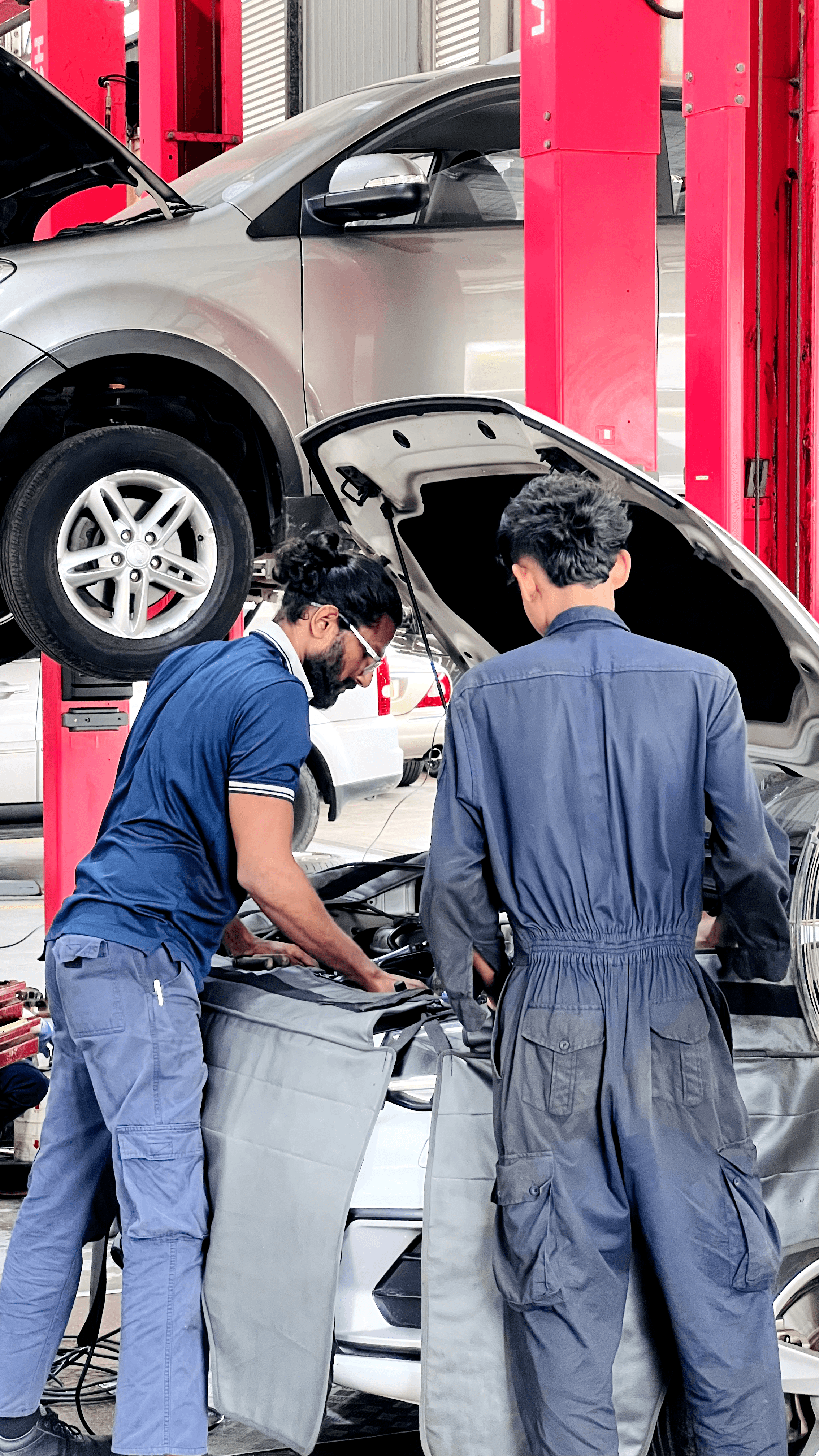 People fixing a car