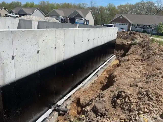 Rub-R-Proof black ashphalt waterproof coating on the exterior of a new home