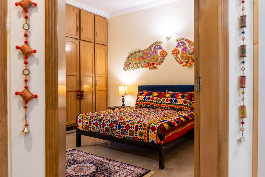 Bright truck art and colorful textiles inside a private room at Coyote Den Hostel Islamabad, Pakistan