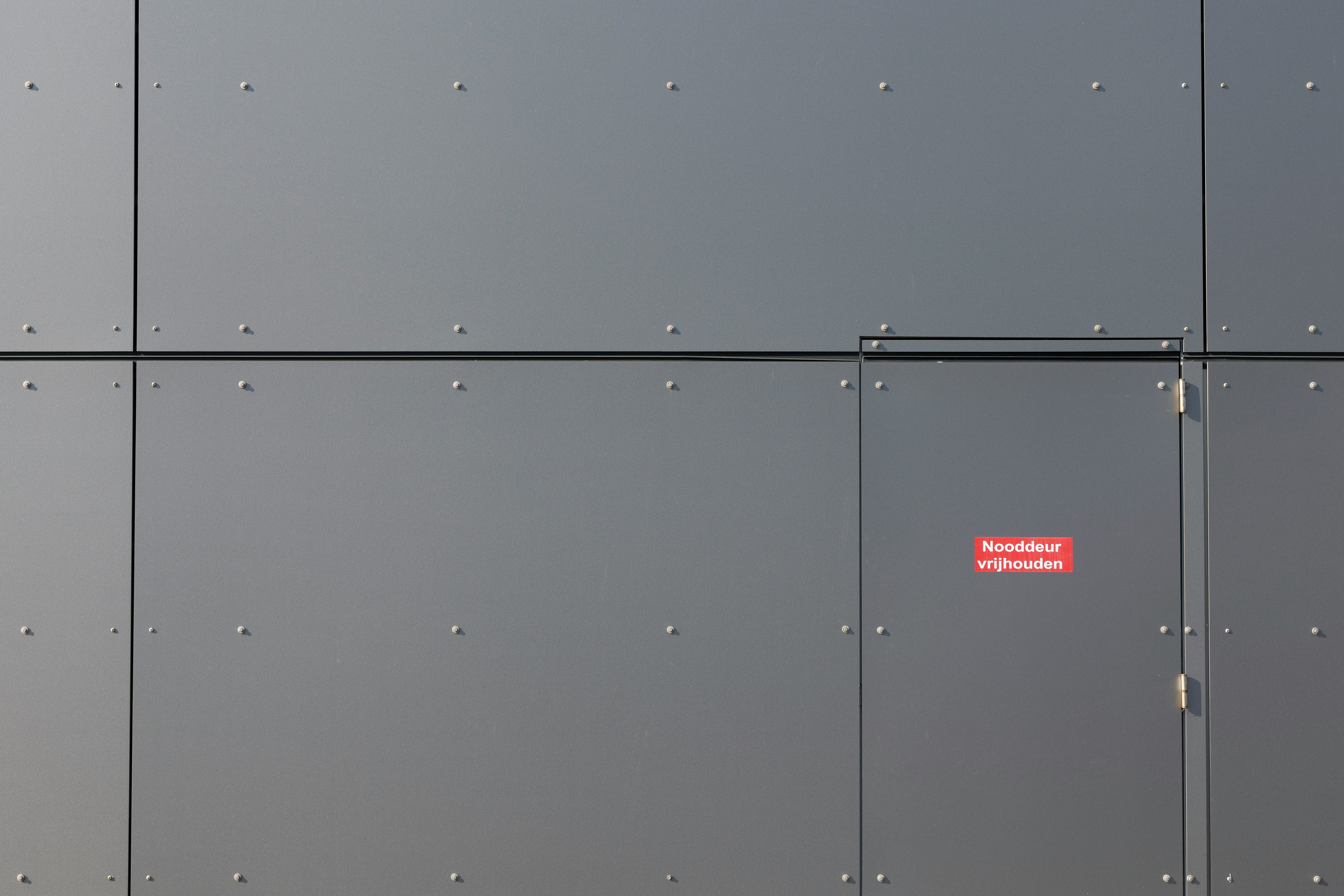 a red street sign on the side of a building