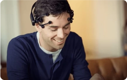 Man wearing Emotiv EEG headset