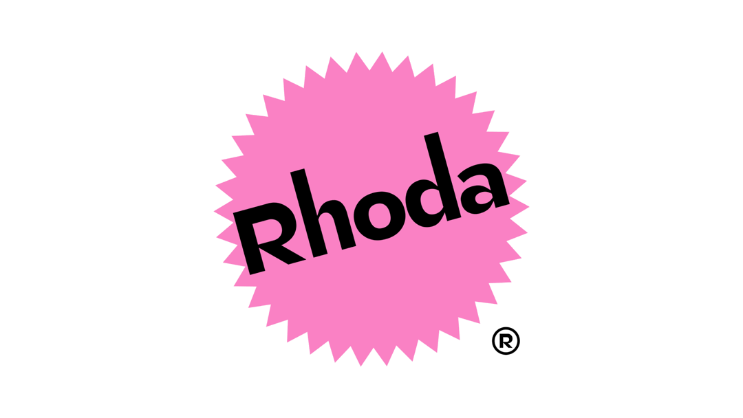 Modern home office setup with a monitor, ergonomic chair, keyboard, and indoor plants near a window with blinds.