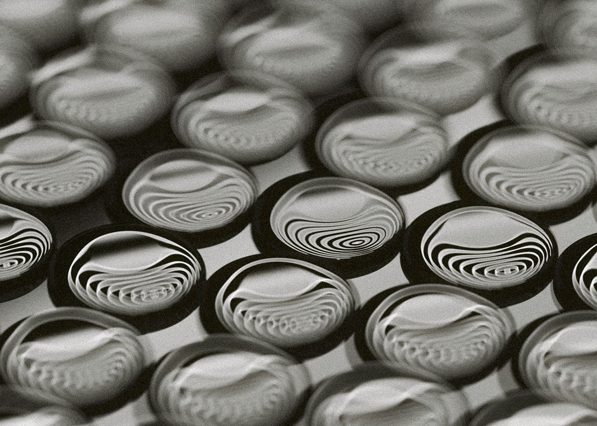 High-contrast black-and-white abstract pattern resembling organic lines or microscopic structures.