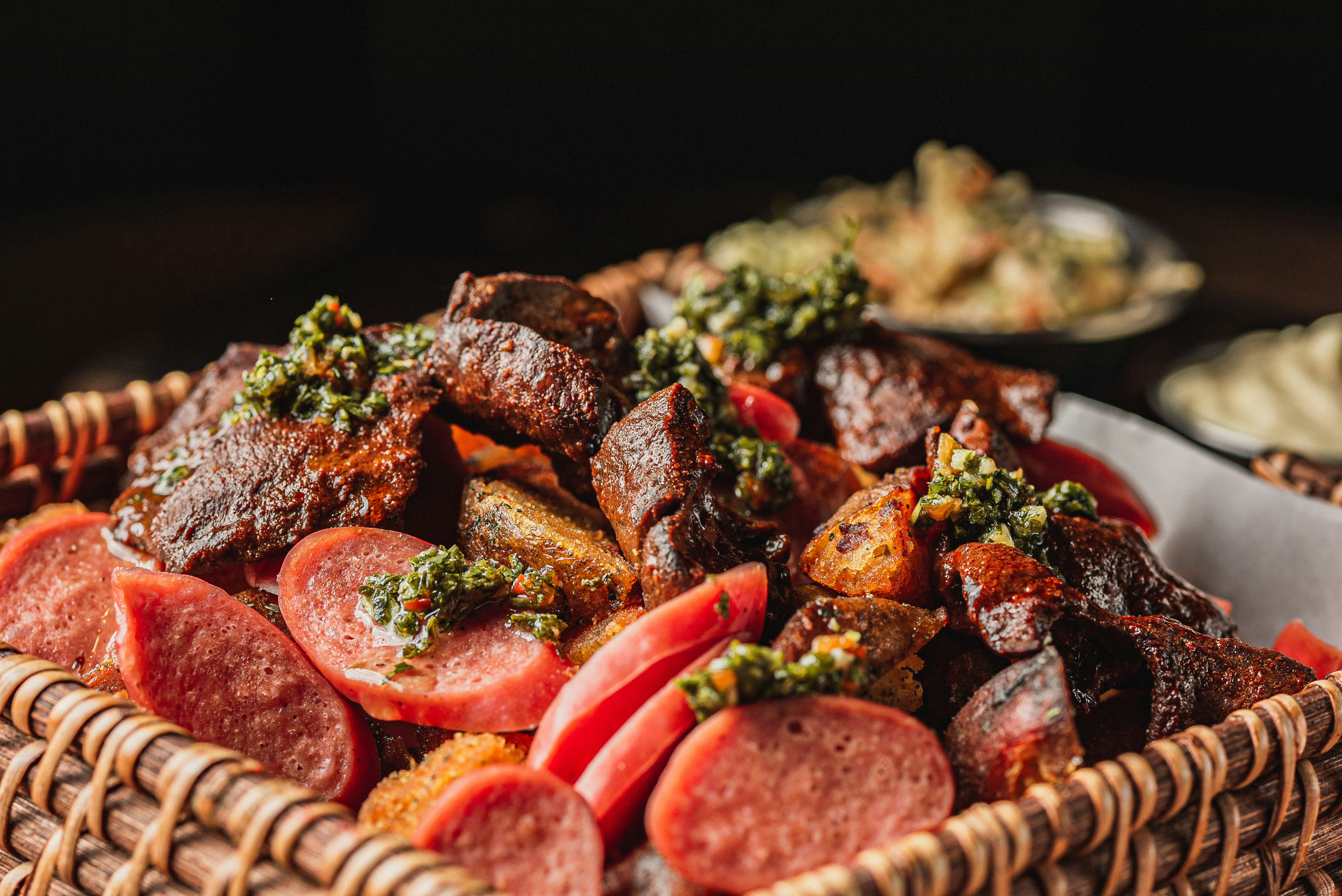 A basket filled with grilled meats and sausages.