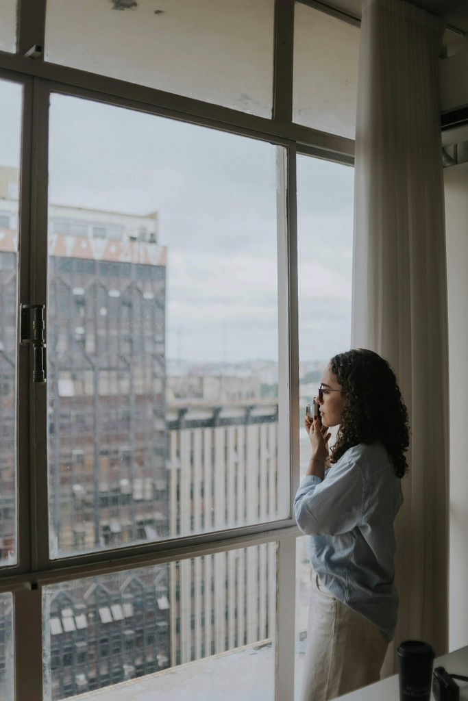 Newcomer family in Canada feeling stressed while reviewing a rental agreement next to moving boxes.