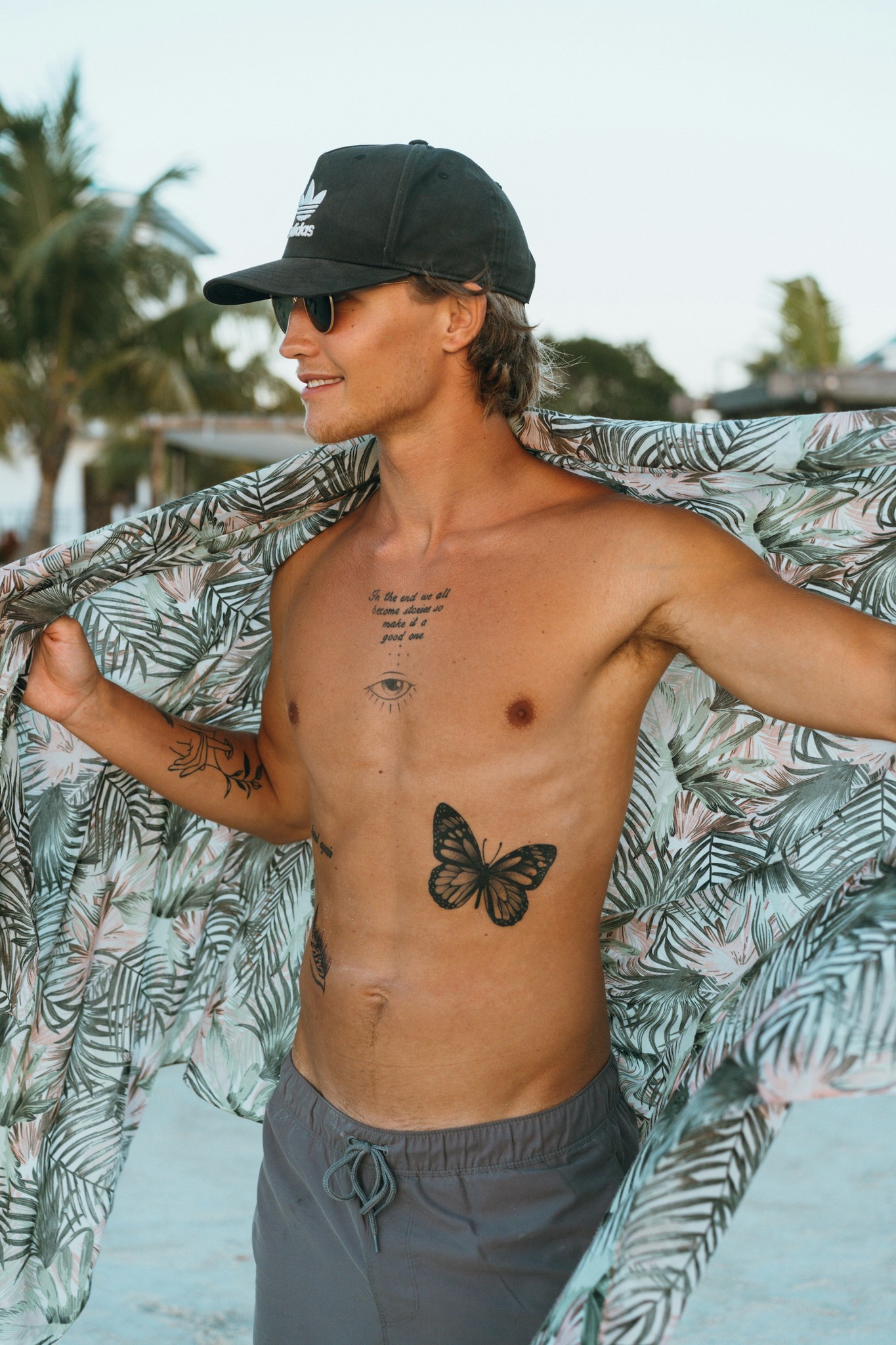 Cliffs overlooking a sandy beach and waves with a crescent moon in the sky