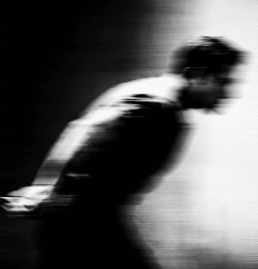 Legs in orange pants and white socks, canvas sneakers in a flower field.