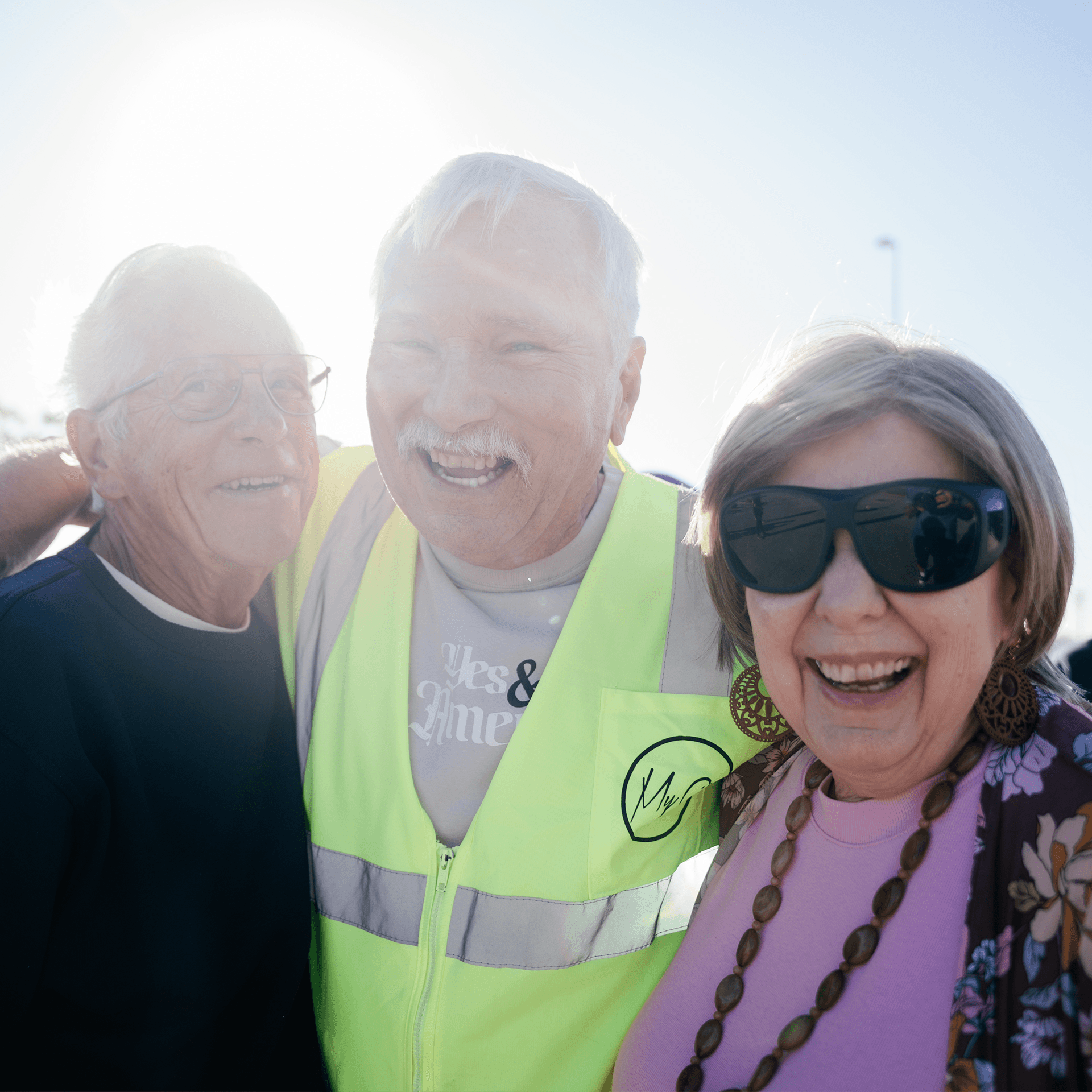 Three friends smiling and laughing together.