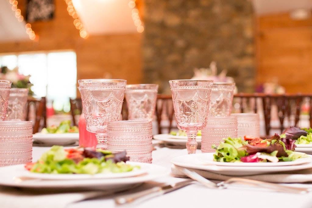 Pink glassware and salads on a reception table at Camp Lenox