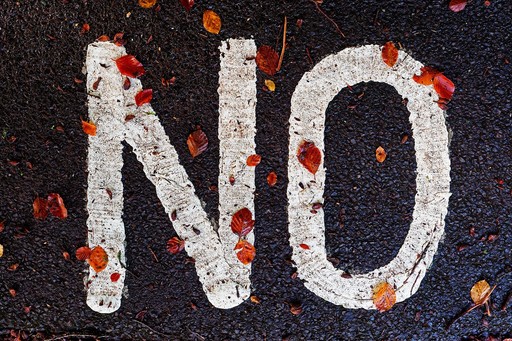 "no" wirtten on the floor, illustrating the french residency getting refused