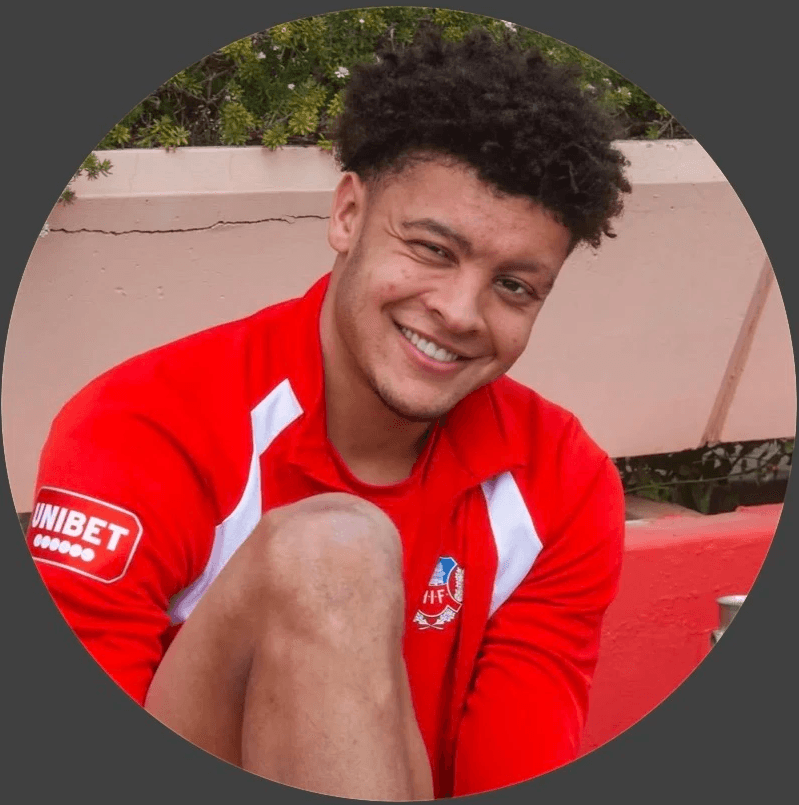 Silhouetted profile of a person in a turtleneck against a teal background. Soft lighting creates a dramatic and contemplative mood.