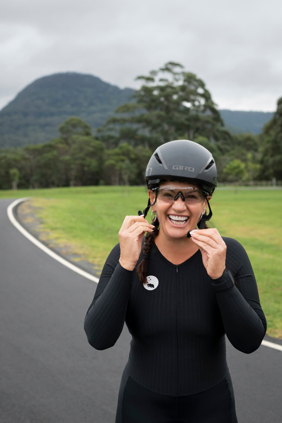 Lily smiling and buckling up her helmet