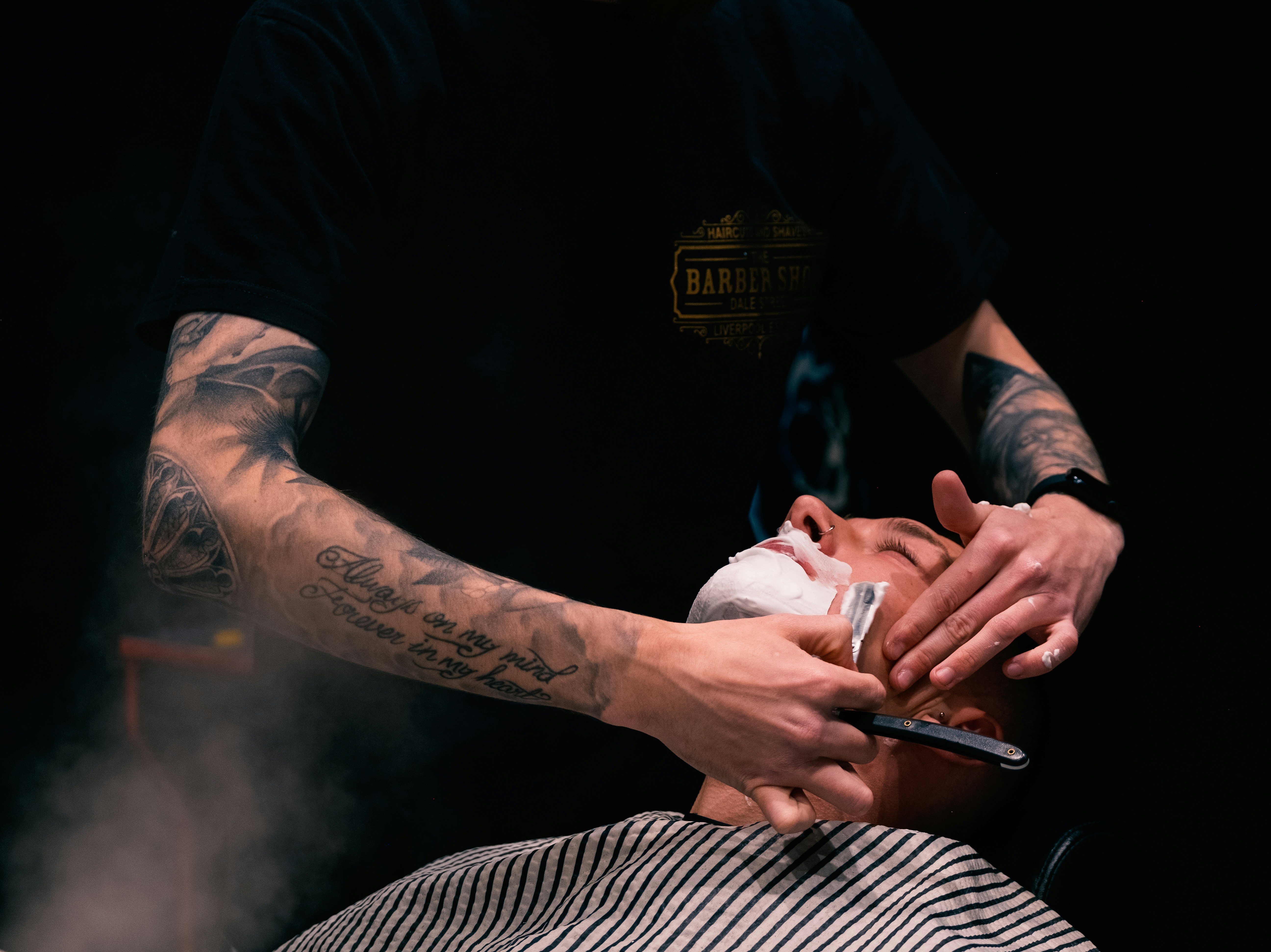 A man getting his hair cut by a barber