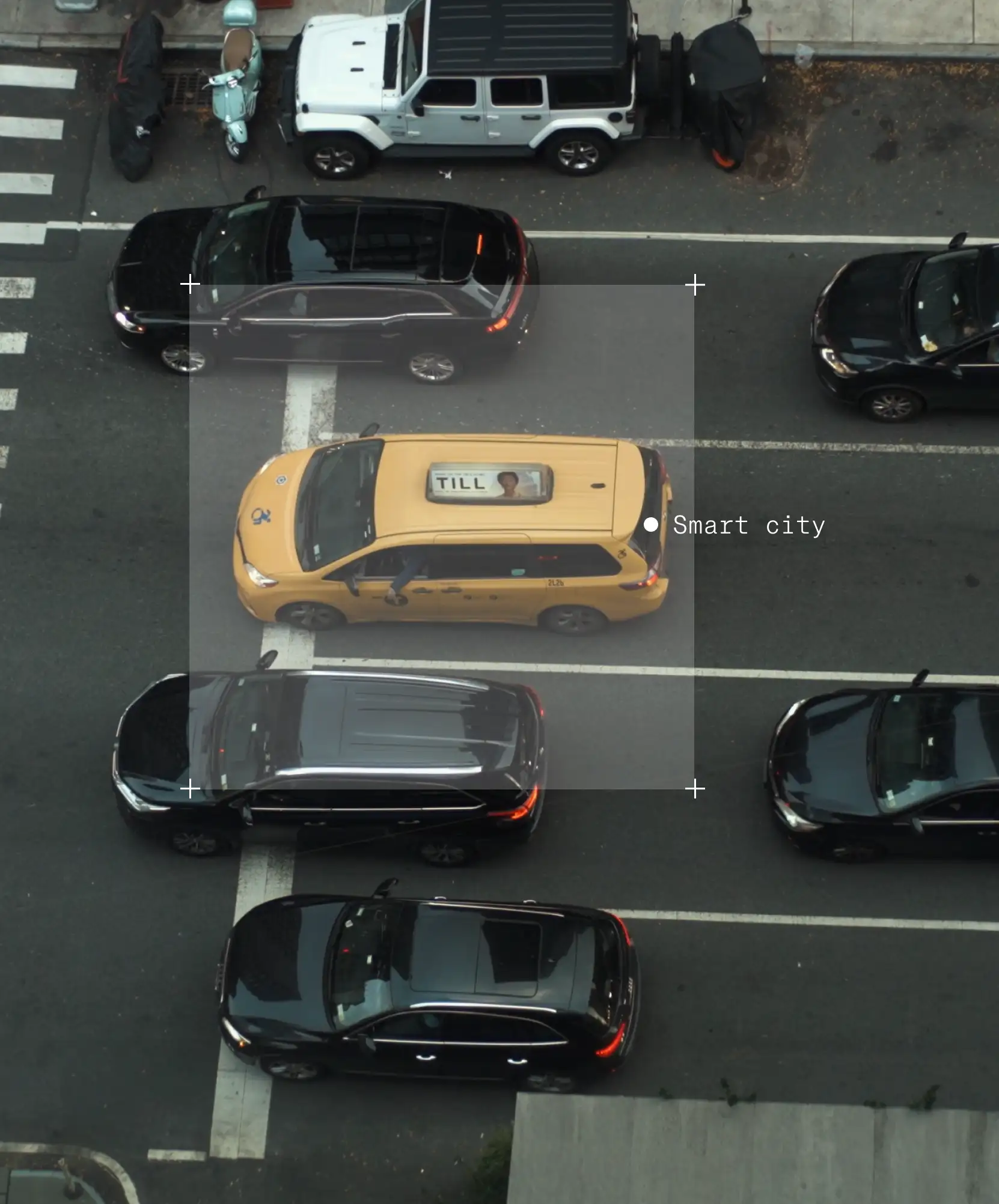 Image of an annotated yellow taxi, among black cars