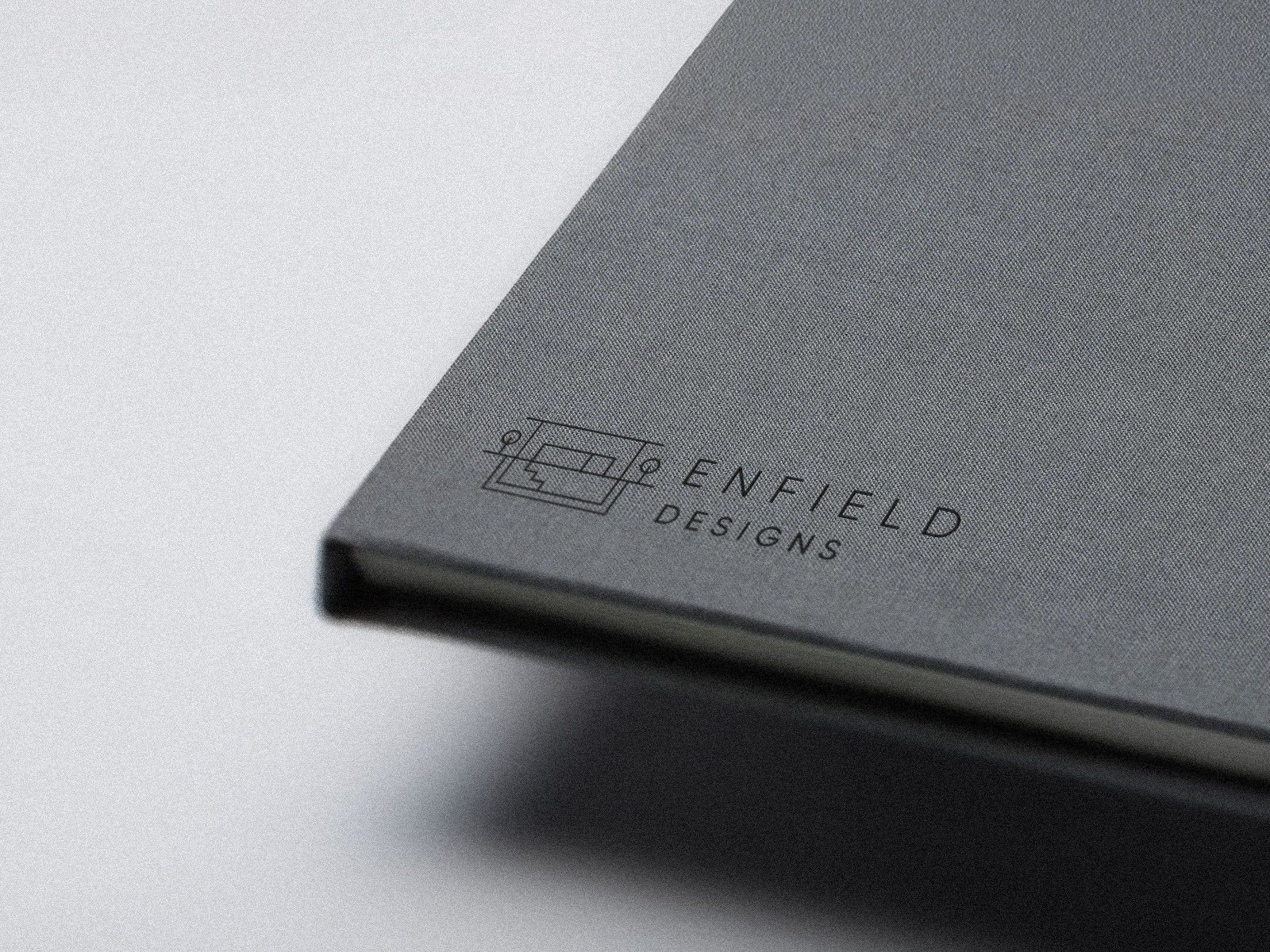 Three models standing in a wheat field, wearing beige suits.