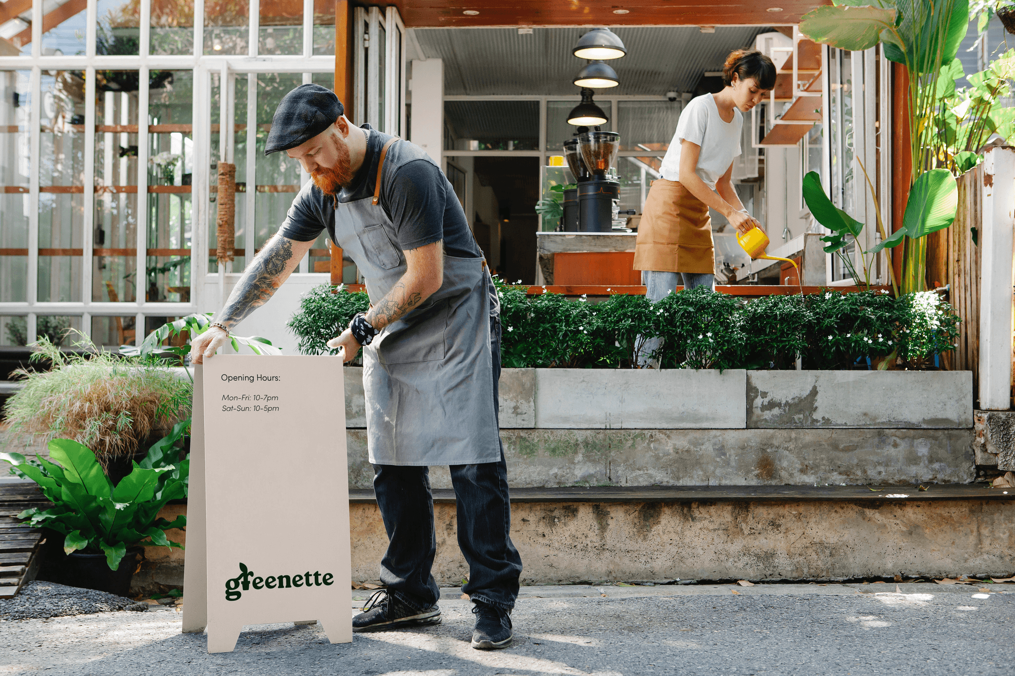 Garden centre signage held by a staff member