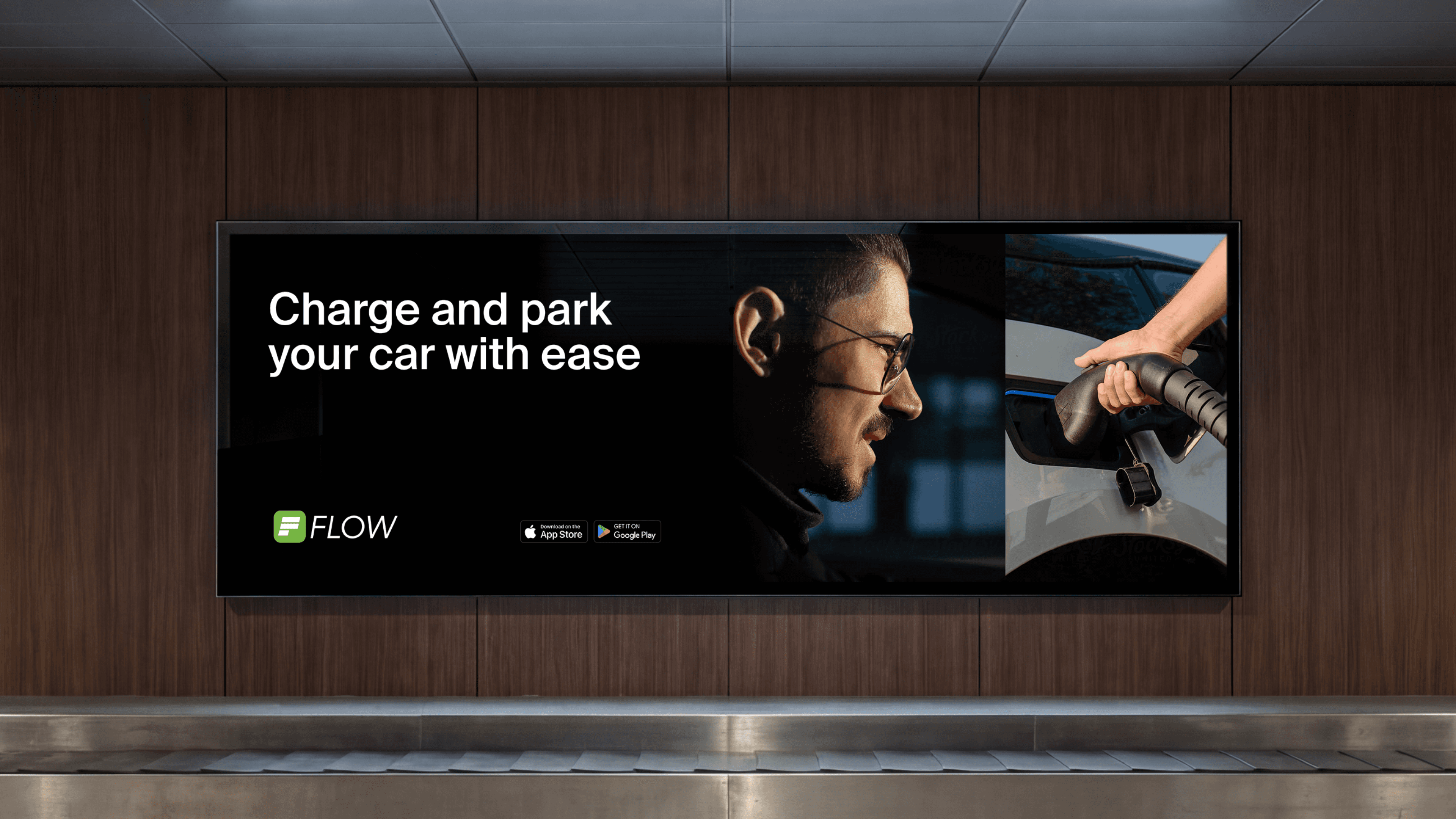 A large-scale digital billboard mockup in a transit hub featuring the APCOA Flow "Charge and park" campaign
