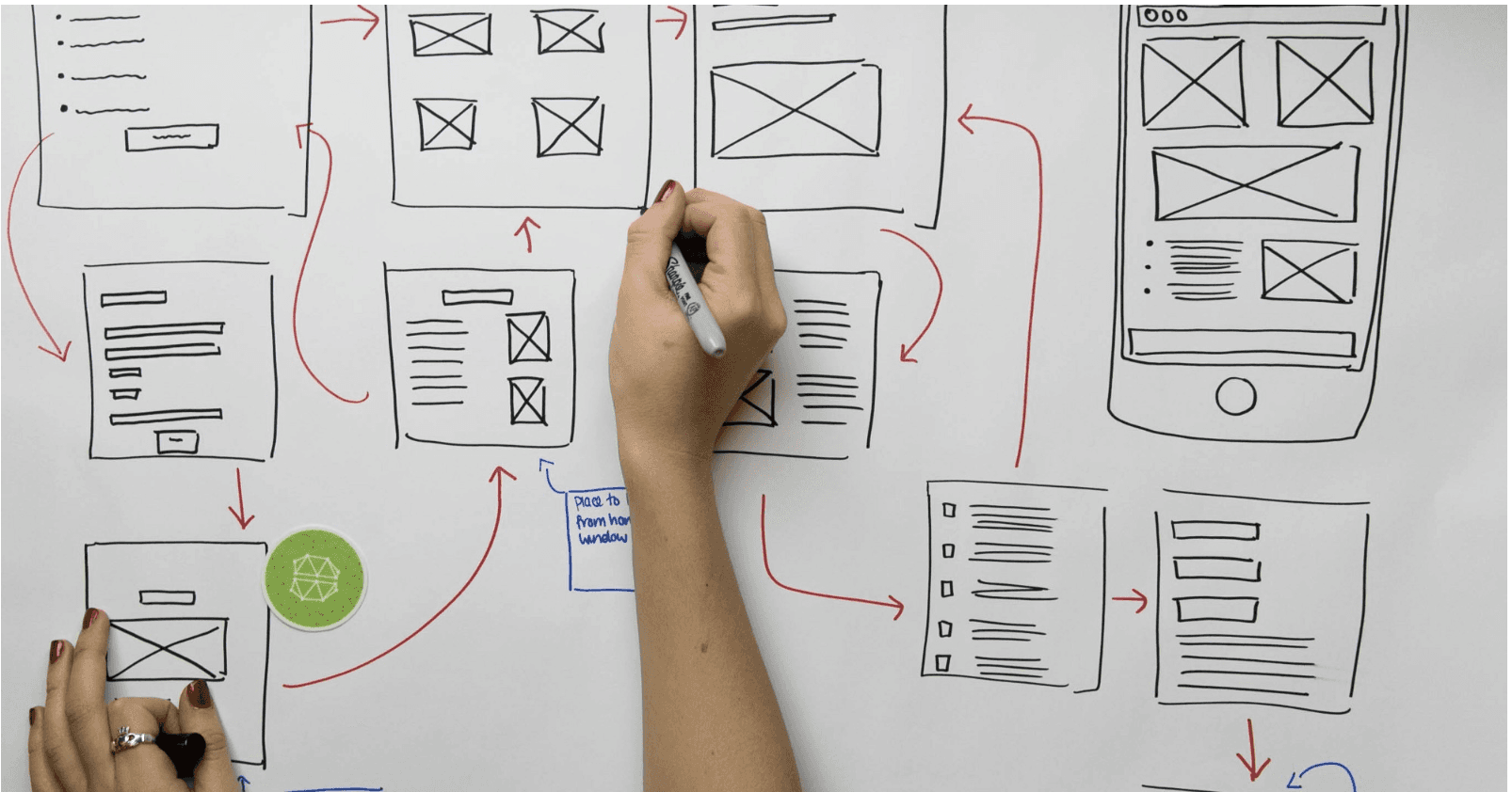 person holding pen near paper